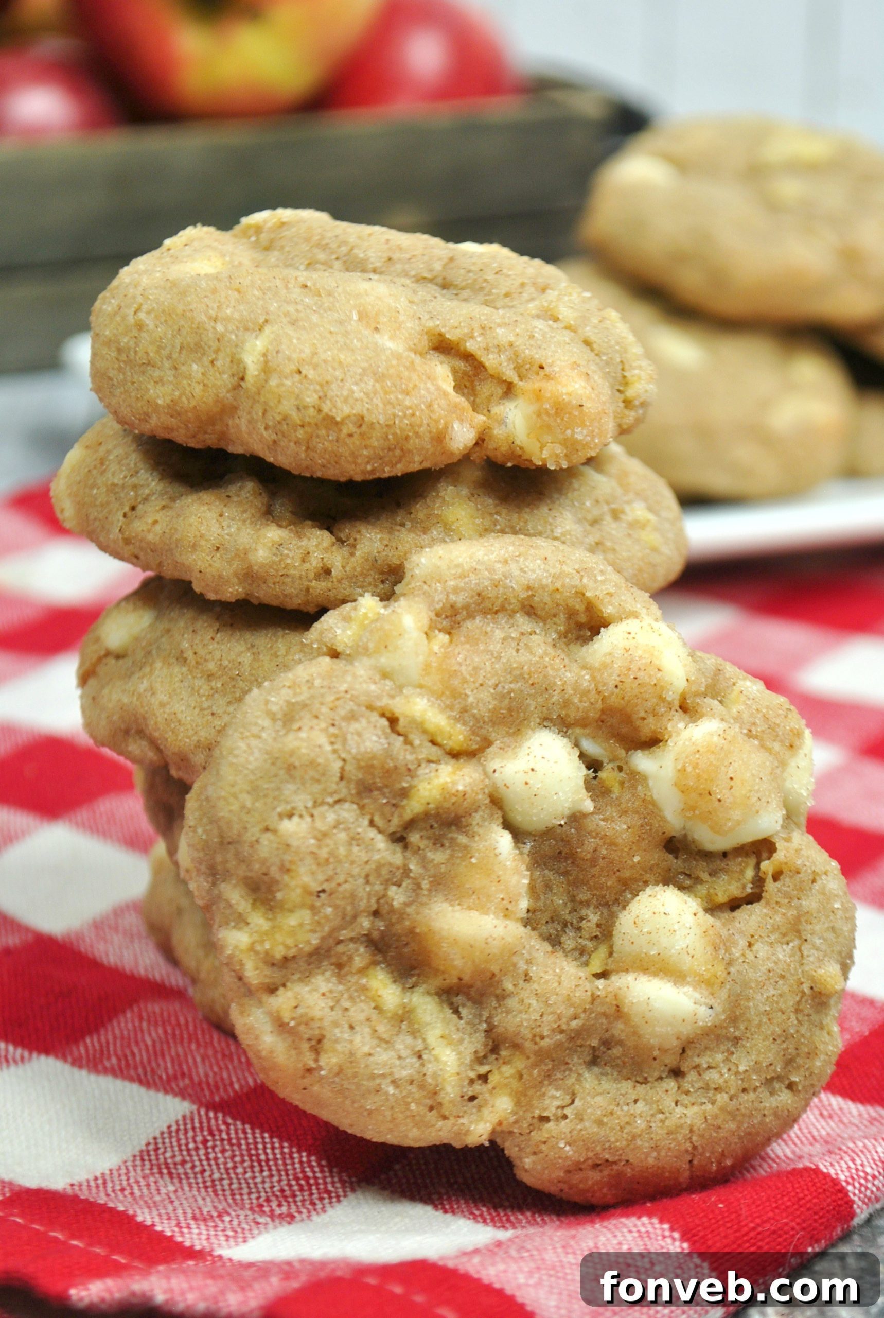 Delicious White Chocolate Snickerdoodle Cookies stacked high, showcasing their soft centers and cinnamon sugar coating.