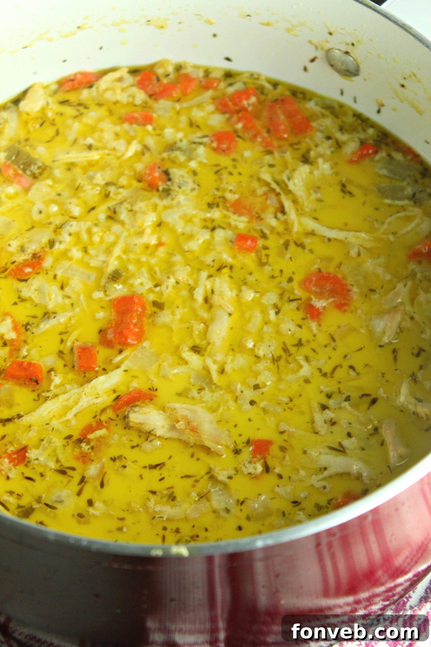 Close-up of the rich, creamy texture of chicken and rice soup.