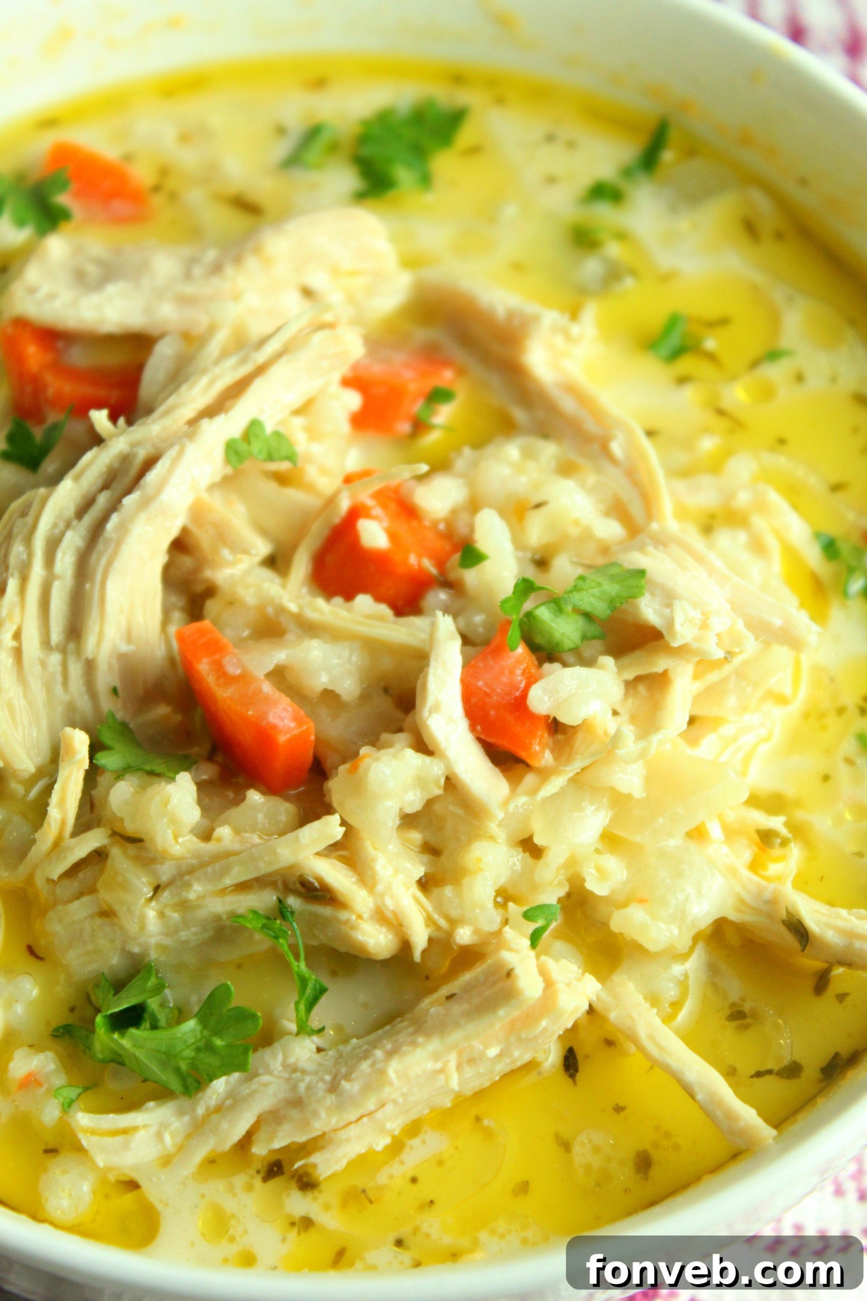 A large pot of homemade chicken and rice soup simmering on the stove.