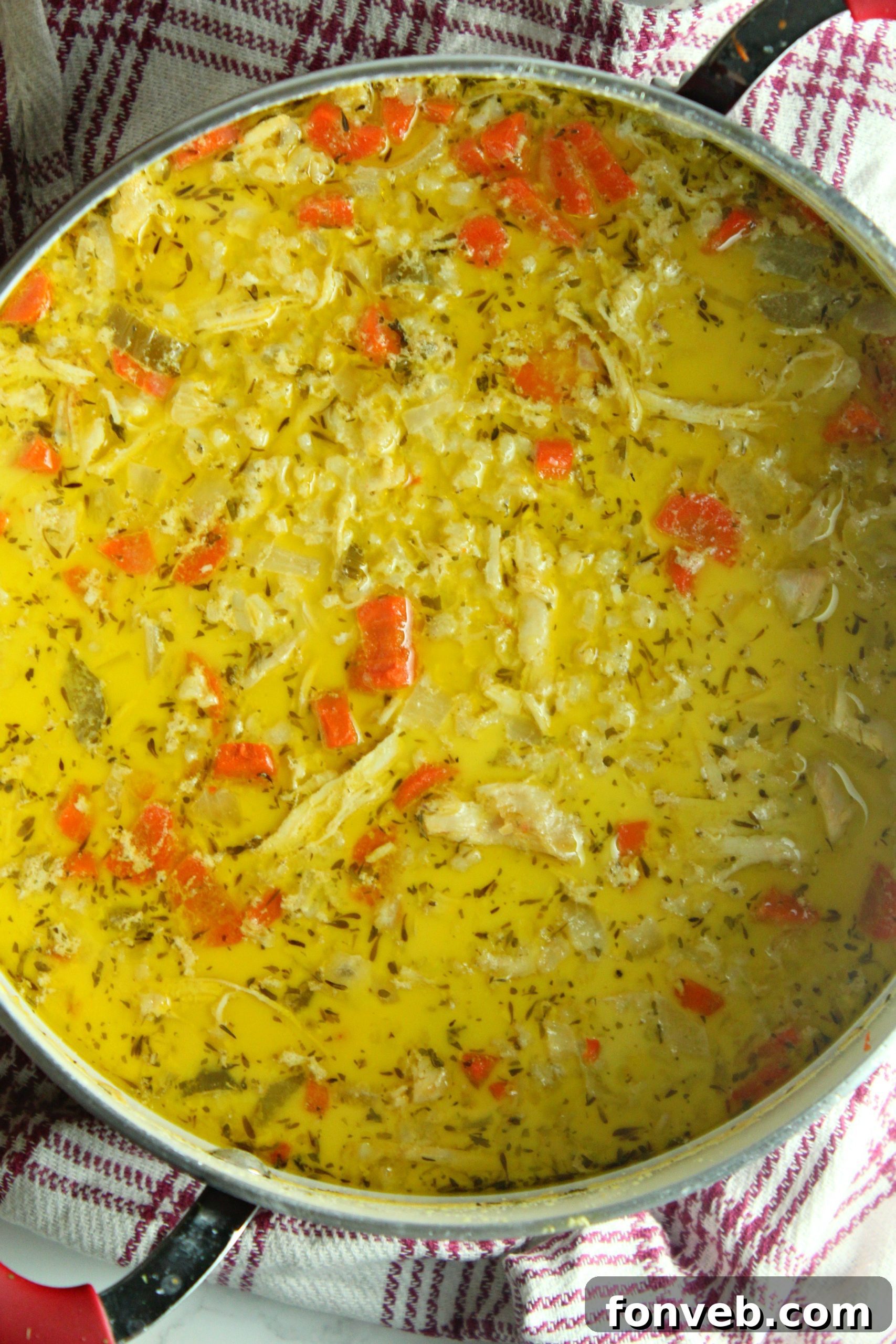Ingredients for chicken and rice soup laid out on a cutting board, ready for preparation.