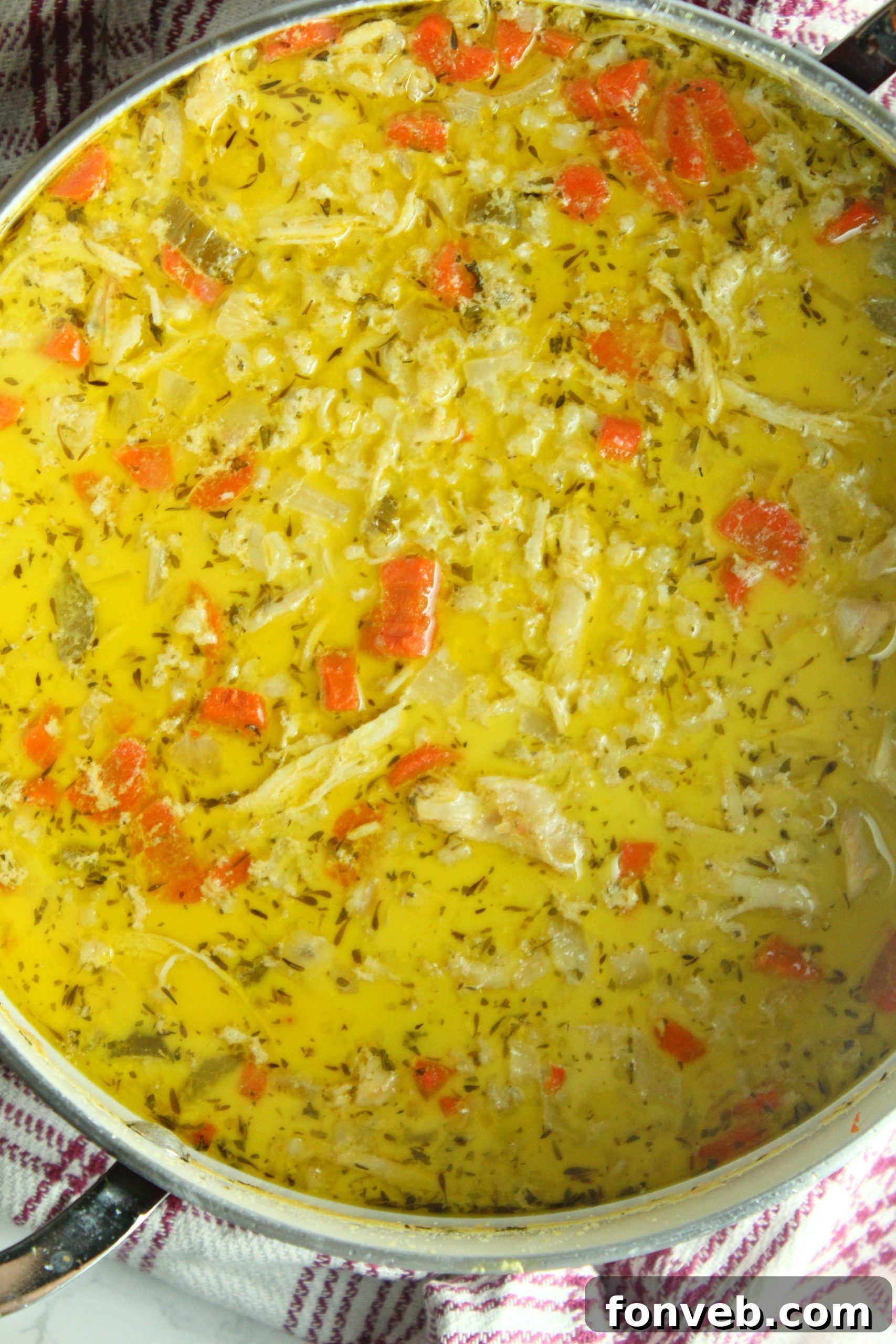 A serving of creamy chicken and rice soup, showing the tender chicken and perfectly cooked rice.