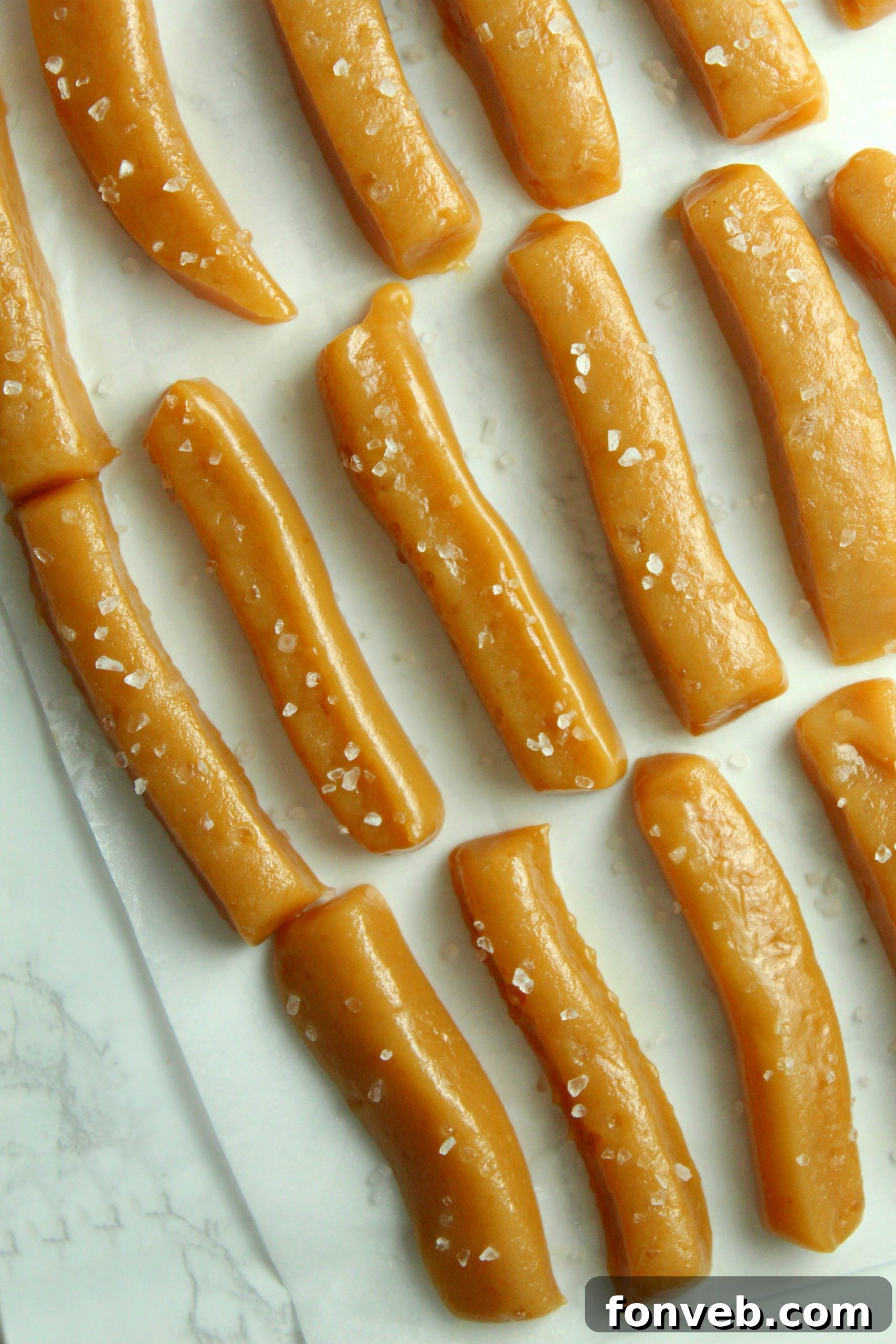 Handcrafted Salted Caramel Bliss 7 More homemade salted caramels on a rustic wooden surface, highlighting their attractive appearance.