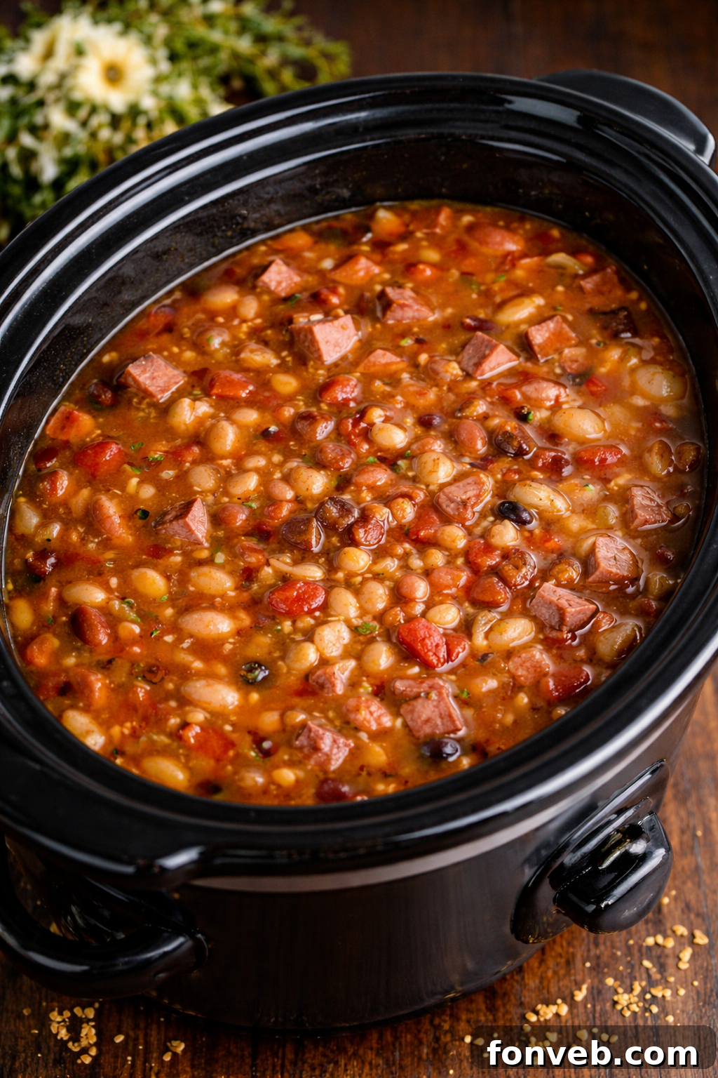 Set It and Forget It Ham and Bean Soup 2 Hearty Slow Cooker Ham and Bean Soup in a black slow cooker, ready to be served