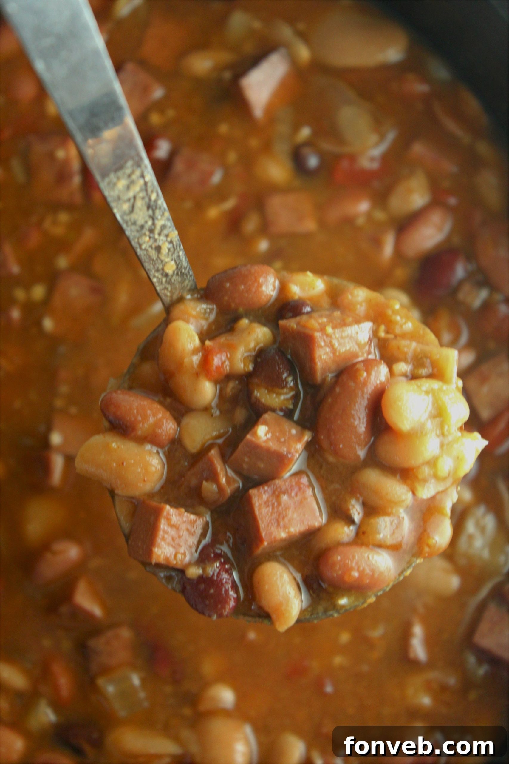 Set It and Forget It Ham and Bean Soup 4 A large pot of Slow Cooker Ham and Bean Soup being stirred