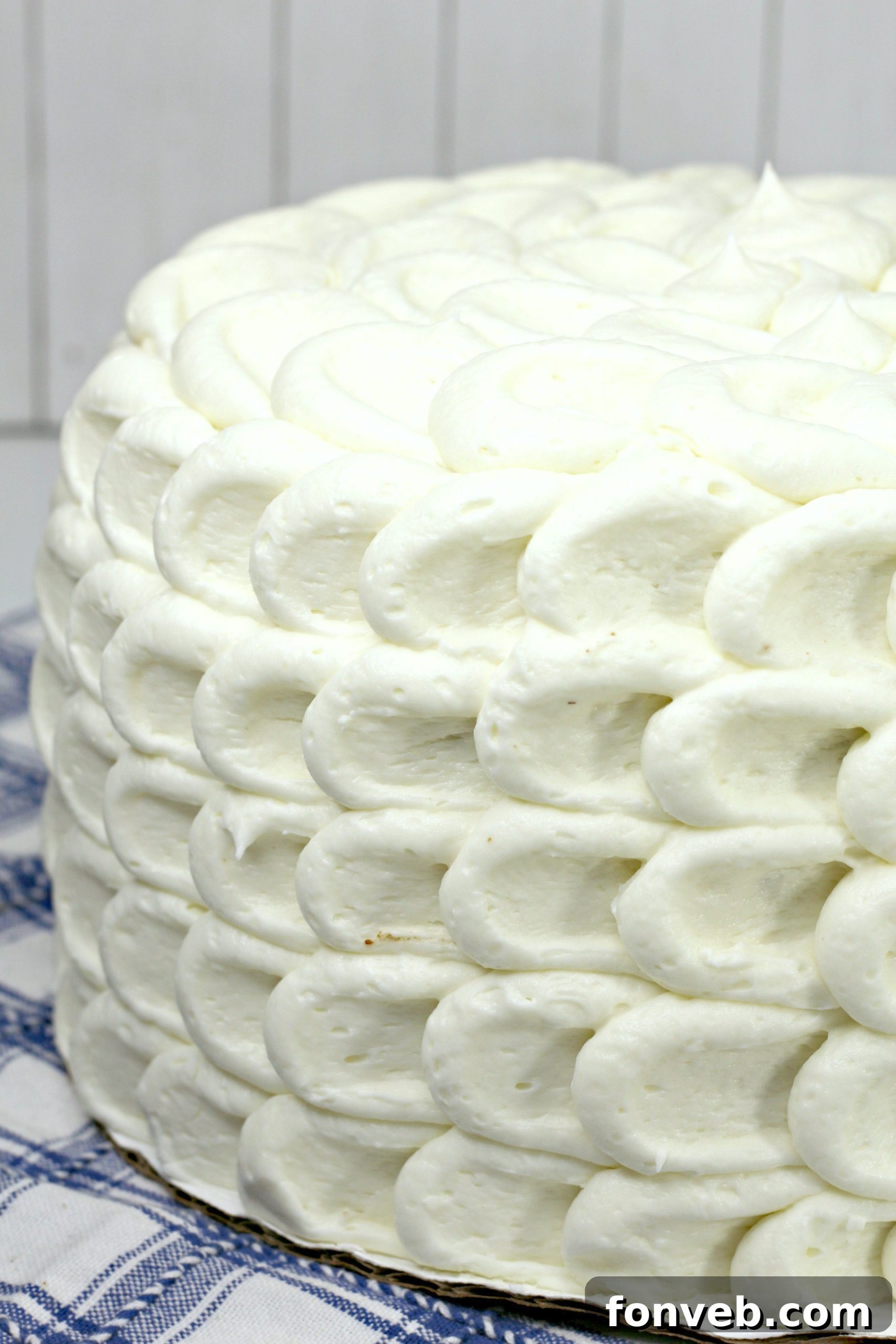 Southern Hummingbird Cake with Luscious Cream Cheese Frosting 4 A beautifully decorated whole Hummingbird Cake on a stand