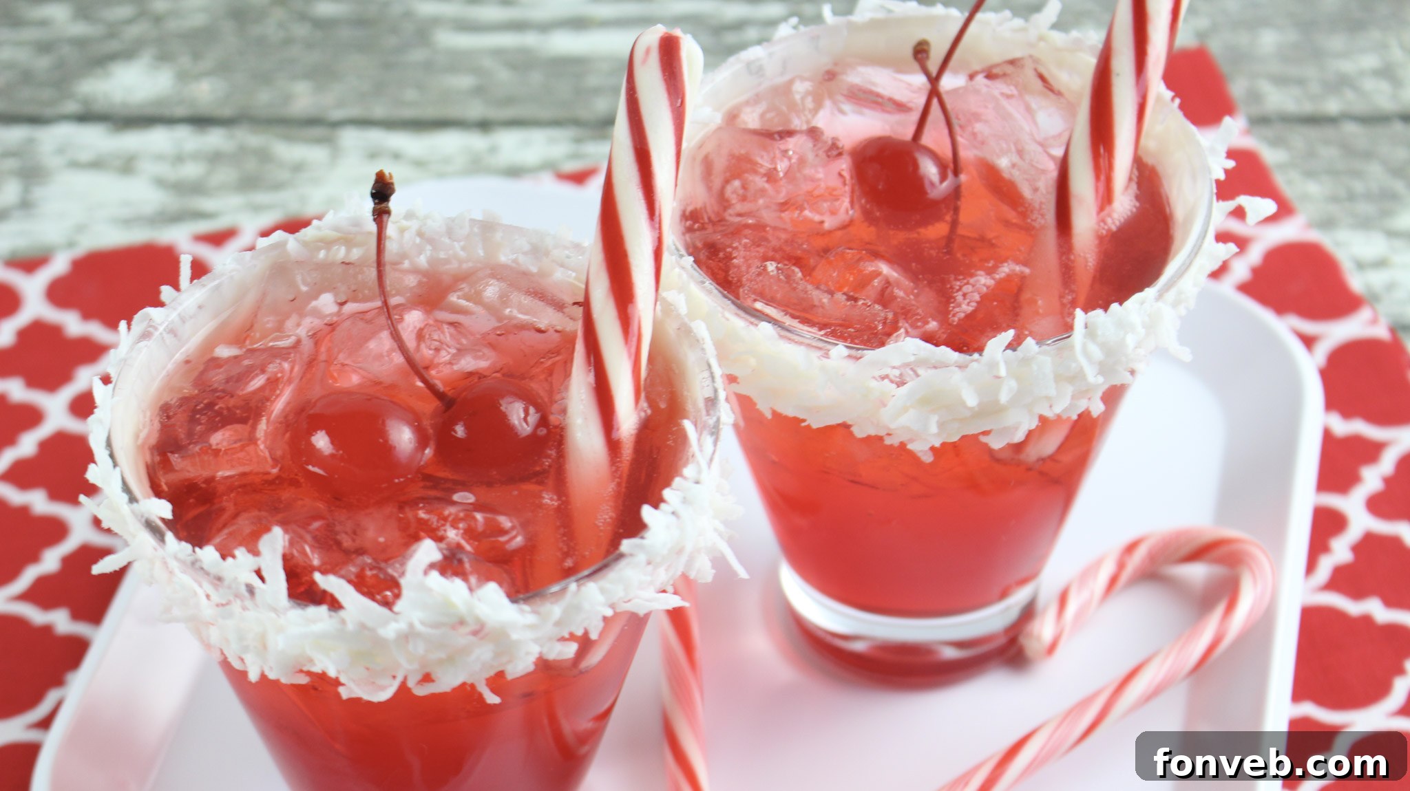 Close-up of a non-alcoholic Santa Hat Mocktail with a fluffy white rim and bright red liquid, perfect for kids.
