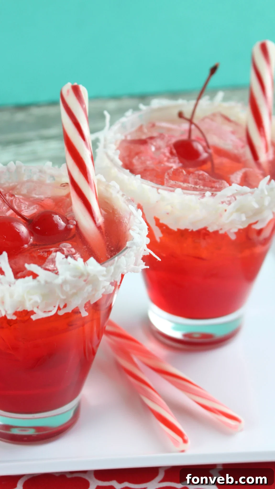 A beautifully presented Santa Hat Cocktail, garnished with a candy cane, ready to be enjoyed at a festive occasion.