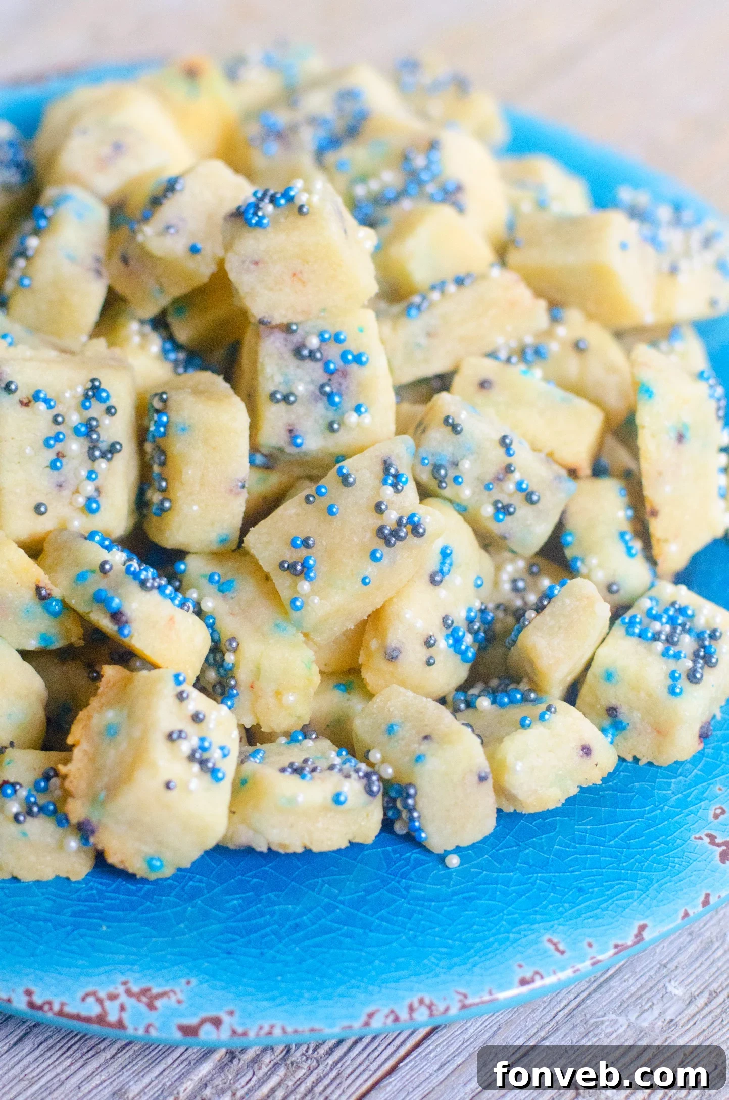 Buttery Winter Shortbread Minis 2 Close-up of buttery Winter Shortbread Bites speckled with colorful sprinkles, ready to be enjoyed.