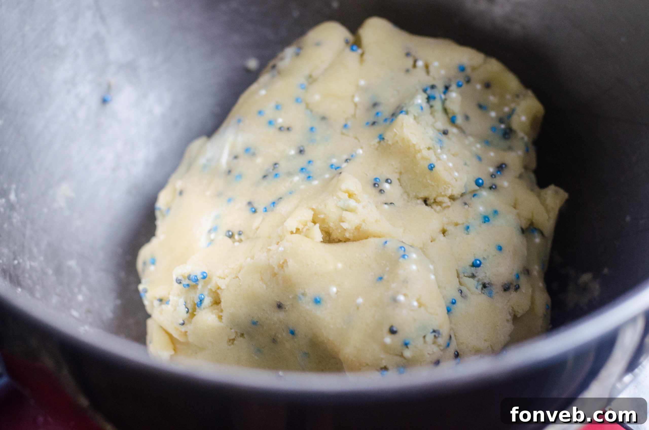 Buttery Winter Shortbread Minis 3 Stacked Winter Shortbread Bites adorned with sprinkles, showcasing their perfect golden-brown edges.