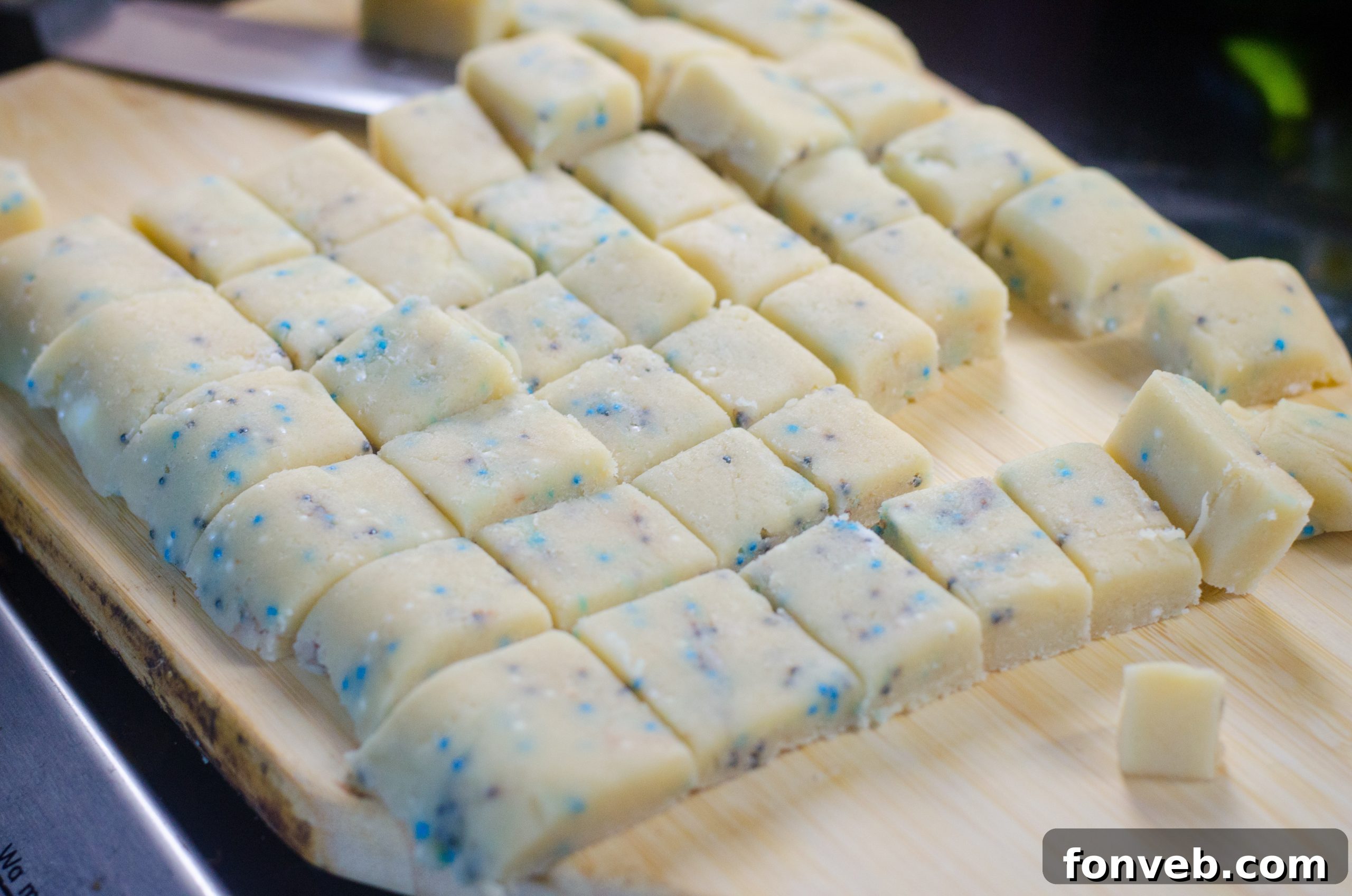 Buttery Winter Shortbread Minis 4 A bowl of freshly baked Winter Shortbread Bites, artfully arranged on a white serving plate, highlighting their sprinkle topping.