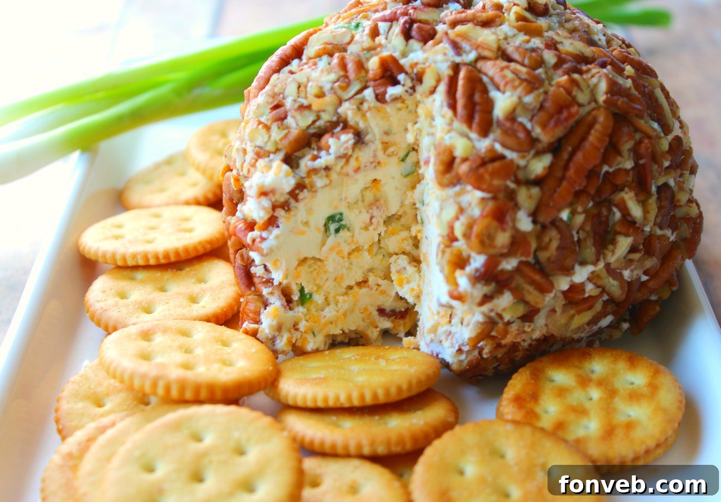 Bacon Cheddar Ranch Cheeseball on a cutting board with knife