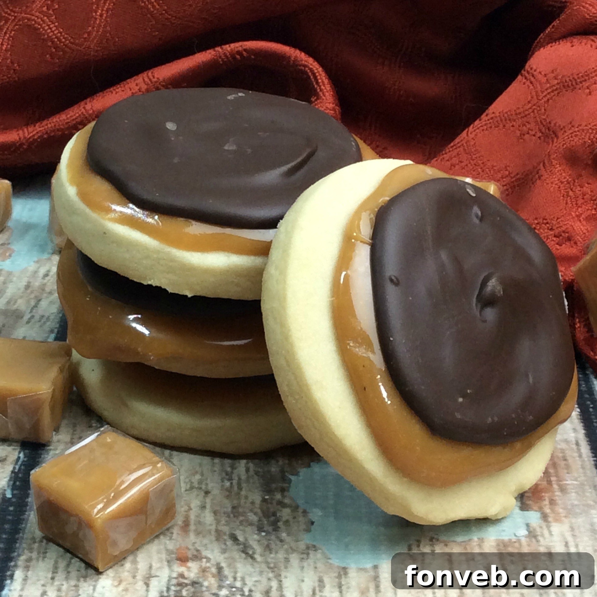 Close-up of a homemade Twix cookie showing the distinct shortbread, caramel, and chocolate layers