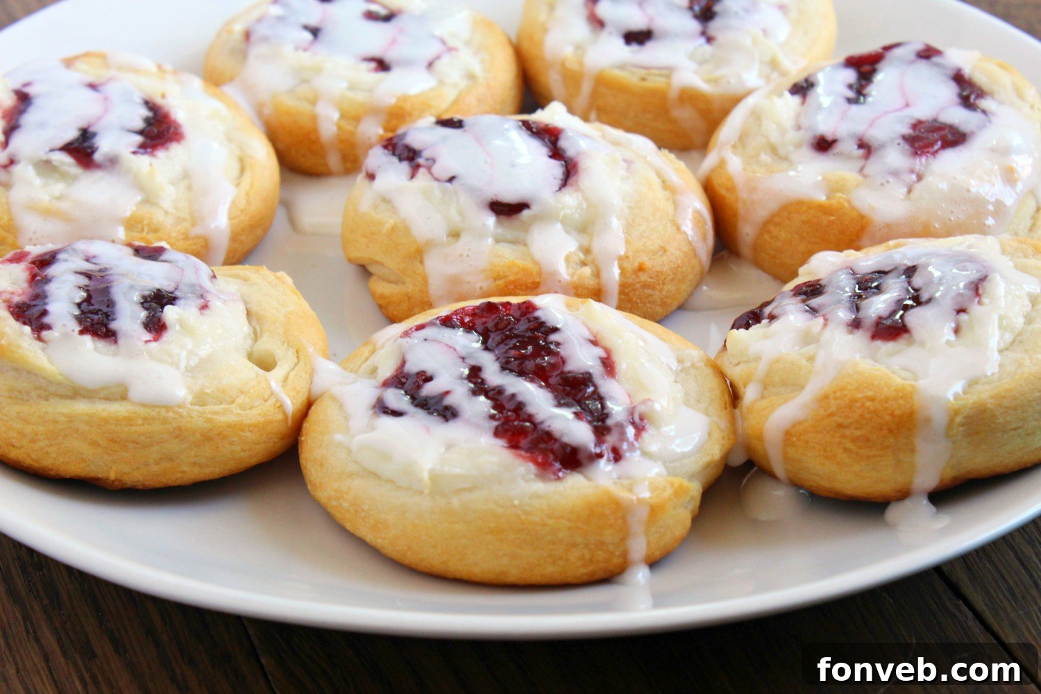 A tray of baked raspberry cream cheese danishes cooling.