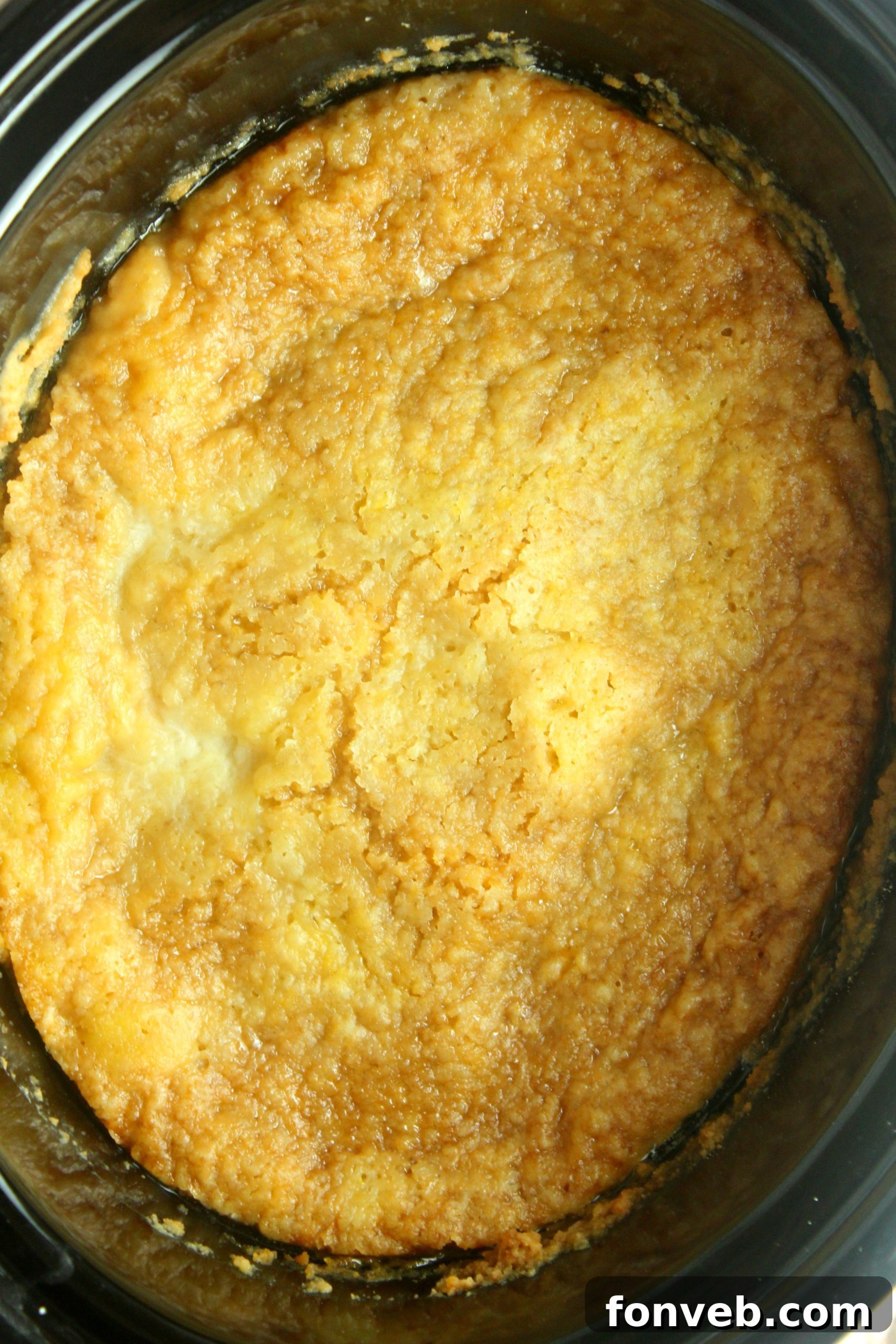 Crockpot Peach Perfection 4 Scoops of slow cooker peach cobbler in a bowl with melting vanilla ice cream