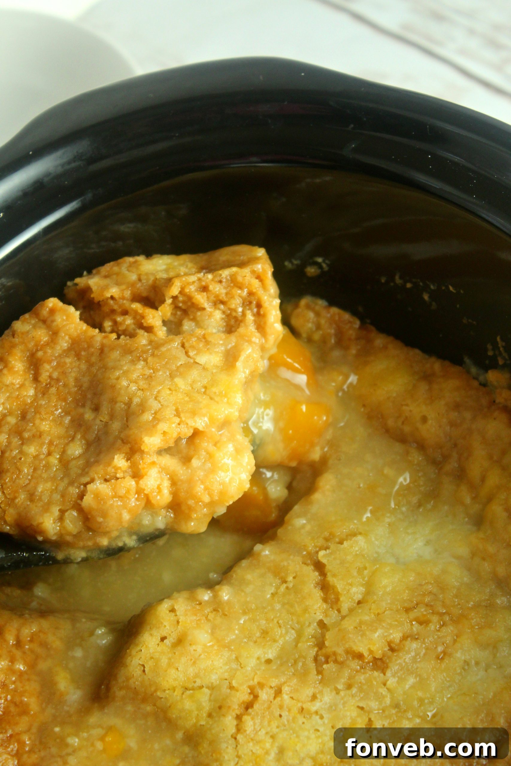 Crockpot Peach Perfection 6 Slow cooker filled with peaches and cake mix before cooking