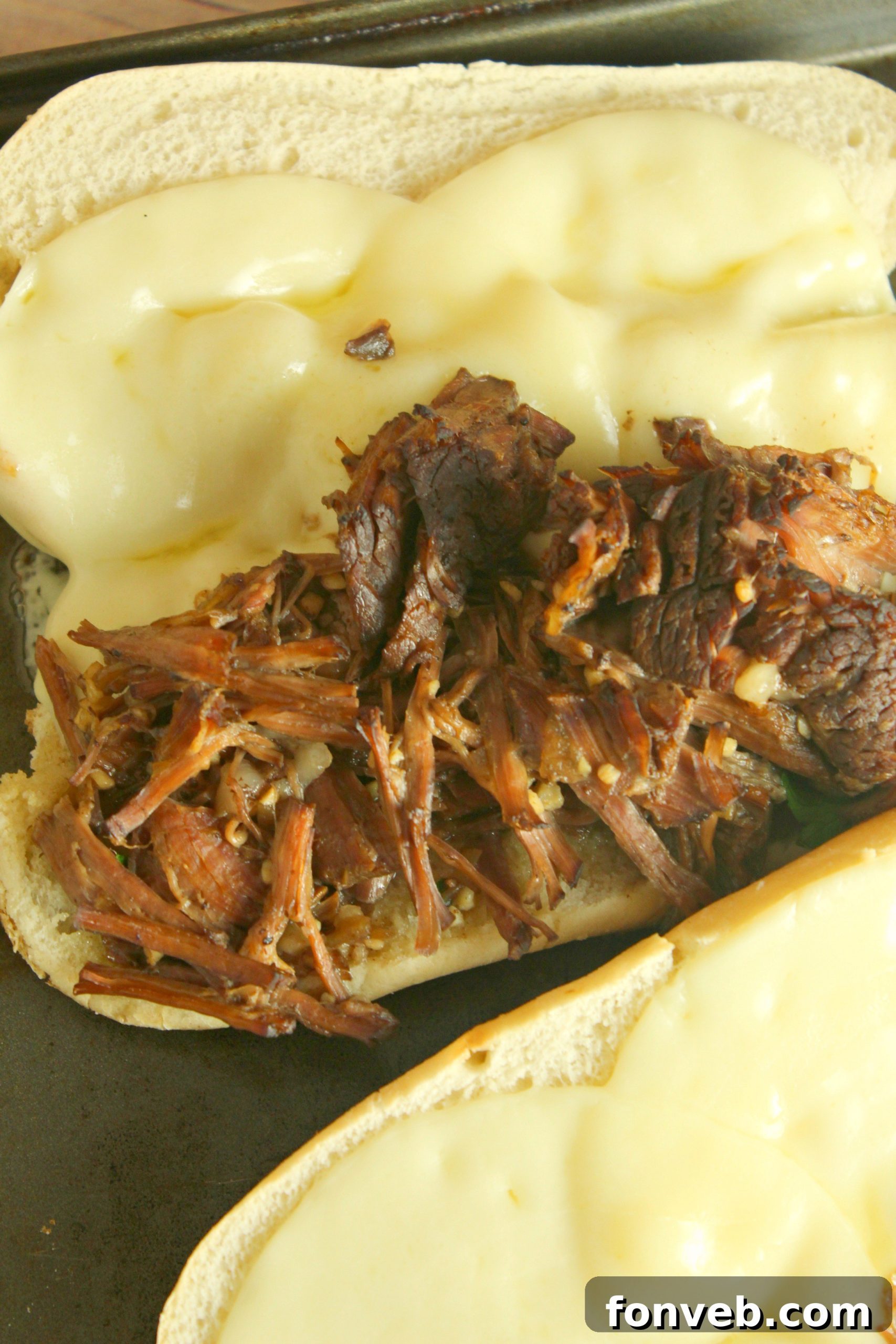 French Dip sandwiches served with a side of crispy French fries, showcasing a complete meal.