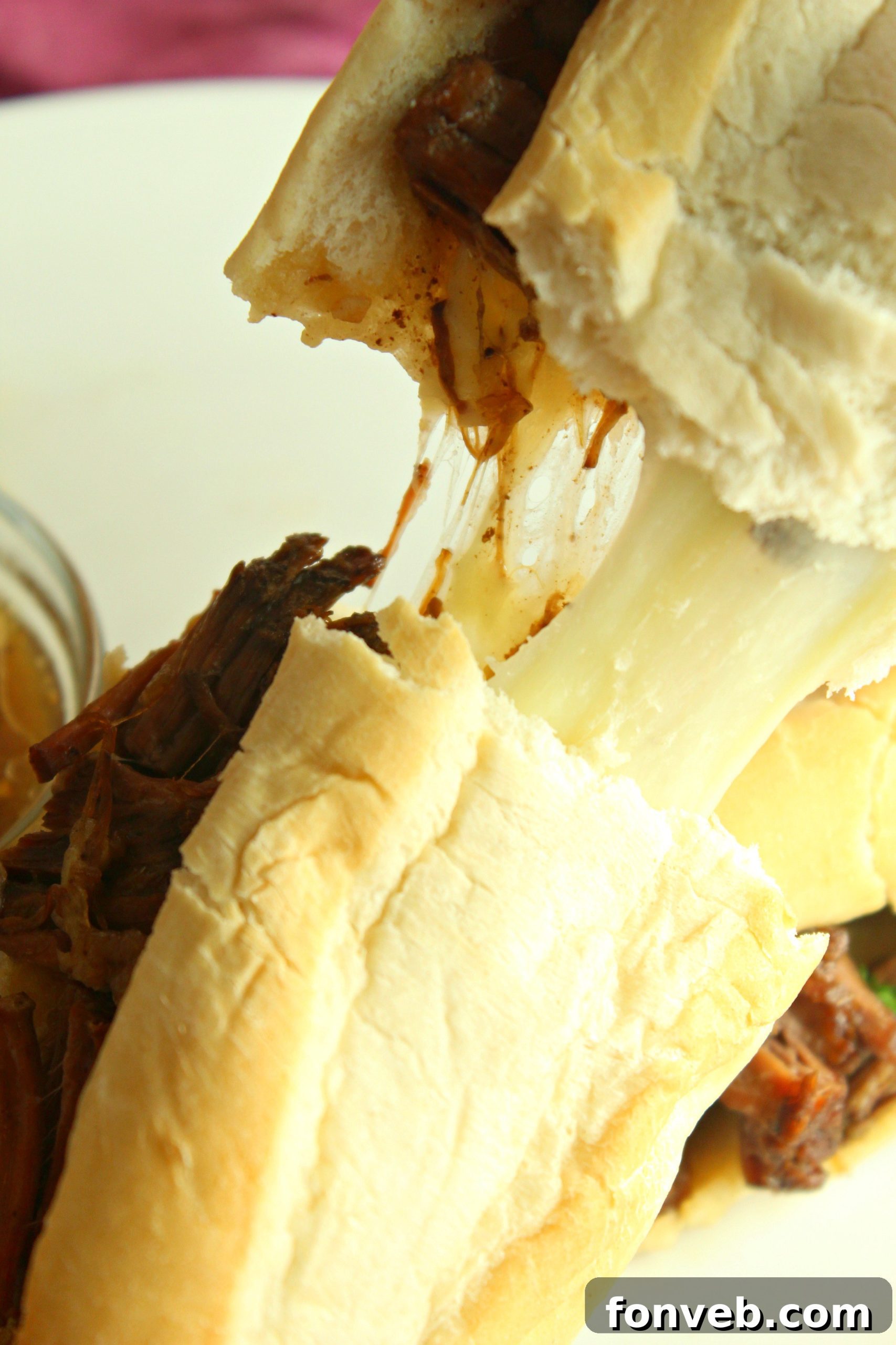 A stack of golden-brown hoagie rolls, ready to be filled with the delicious slow-cooked French Dip beef.