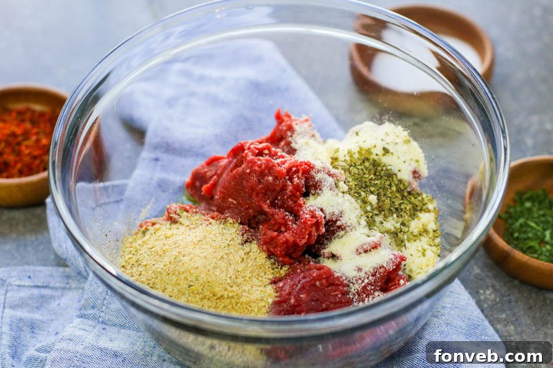 Rustic Tuscan Meatball Soup 3 Close-up of a rustic wooden spoon scooping Tuscan Meatball Soup, showcasing a perfectly formed, golden-brown meatball amidst the rich broth and vibrant kale.