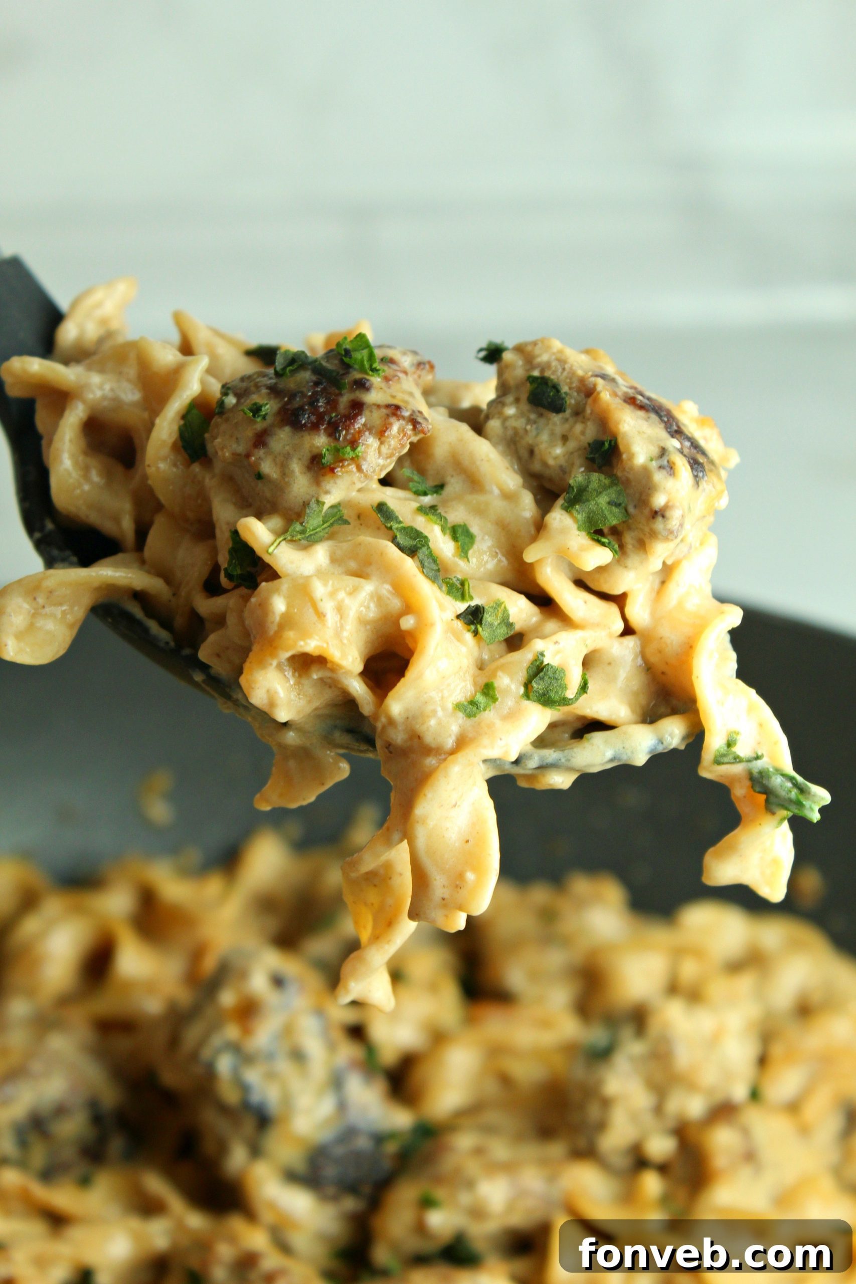Velvety French Onion Sausage Pasta 11 A bowl of Creamy French Onion Sausage Pasta, served with a side of garlic bread and a fresh salad.