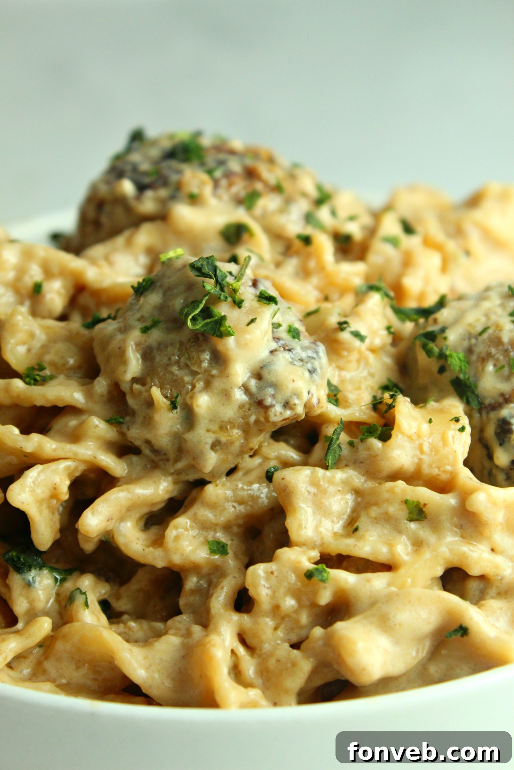 Velvety French Onion Sausage Pasta 8 Close-up of Creamy French Onion Sausage Pasta with a sprinkle of fresh herbs.