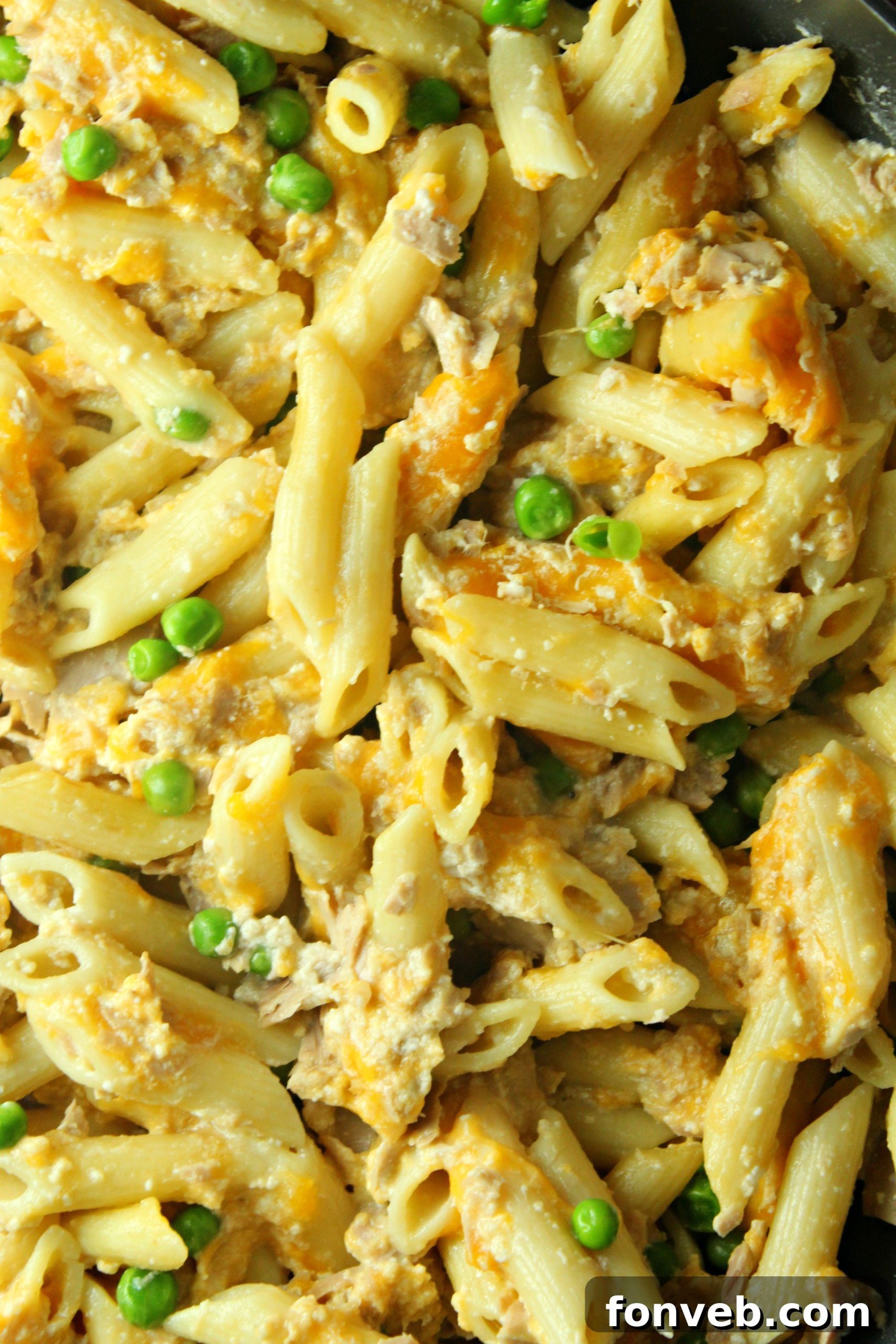 Golden Tuna Cheese Bake 5 A large skillet filled with creamy Cheesy Tuna Casserole, steaming hot and ready to be served, highlighting the pasta and sauce.