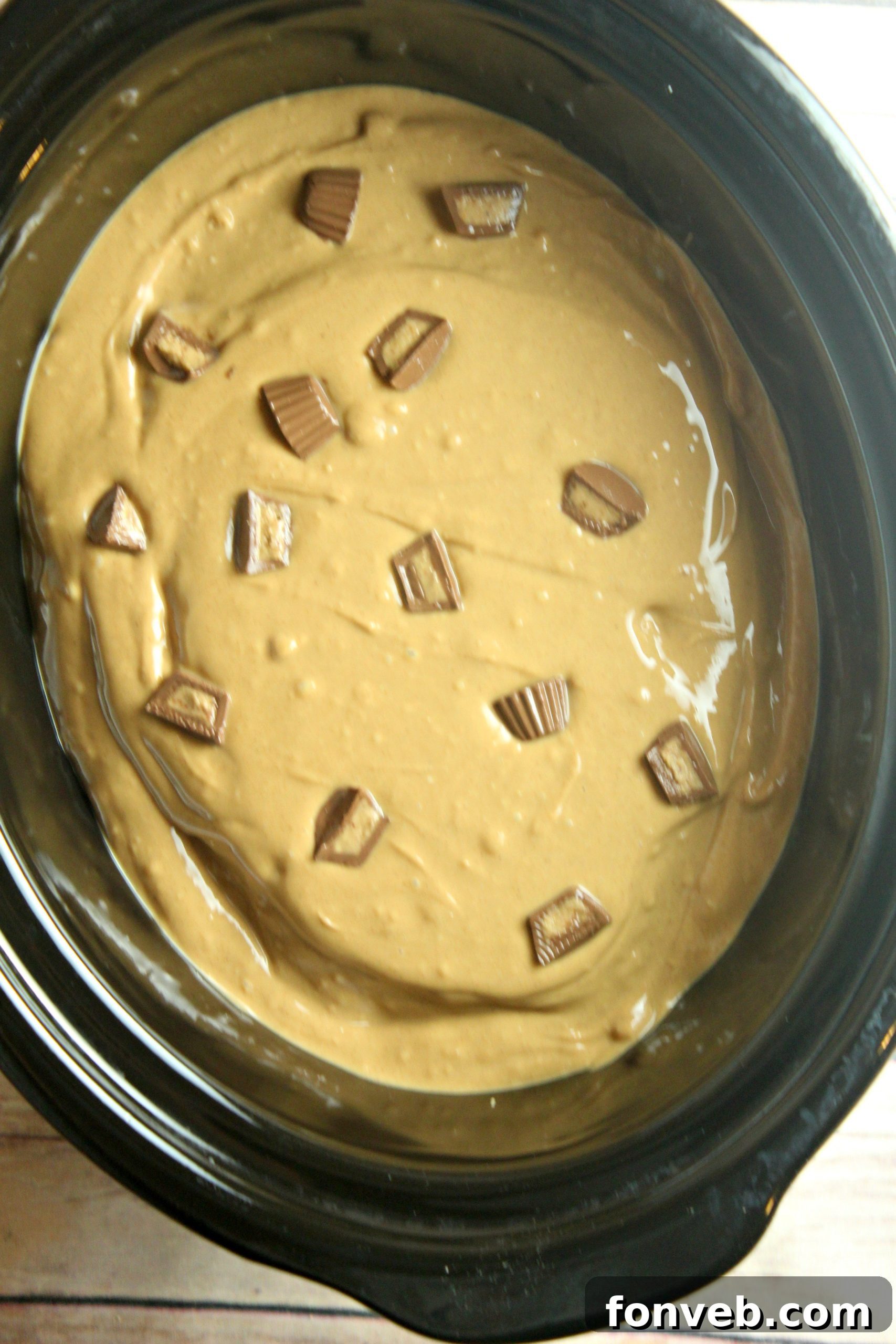 Slow Cooker Reeses Peanut Butter Chocolate Fudge Cake 4 A generous serving of slow cooker Reese's peanut butter chocolate cake with a rich frosting