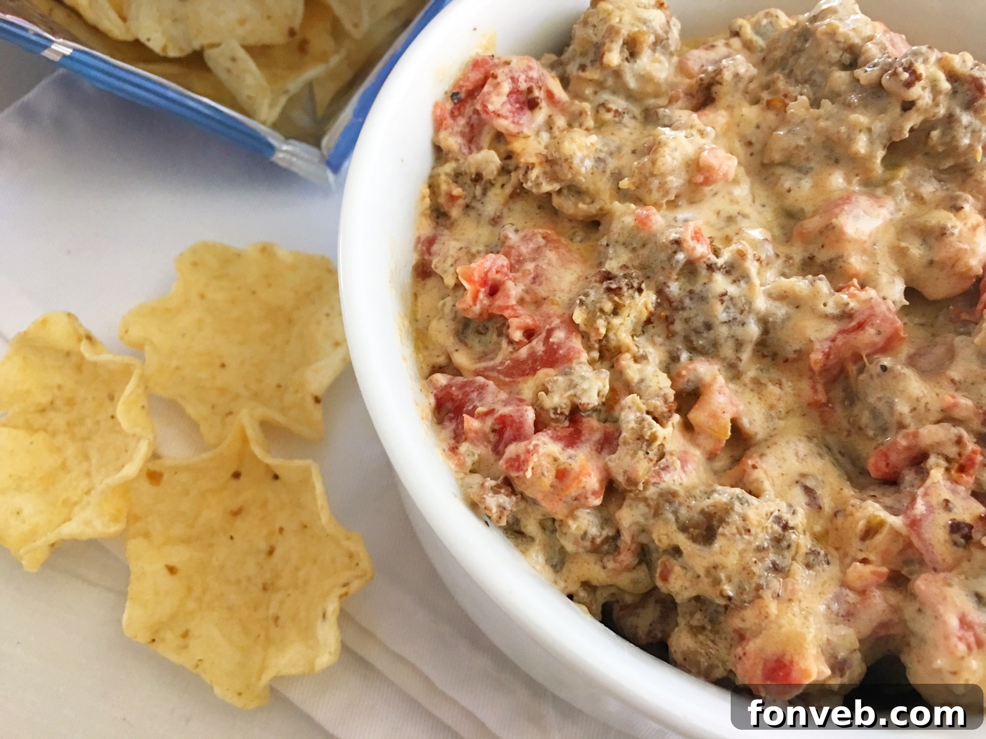 Mouthwatering Three-Ingredient Spicy Sausage Dip 6 Another appealing shot of the creamy sausage dip in a bowl, with a few pieces of sausage visible, inviting viewers to taste.