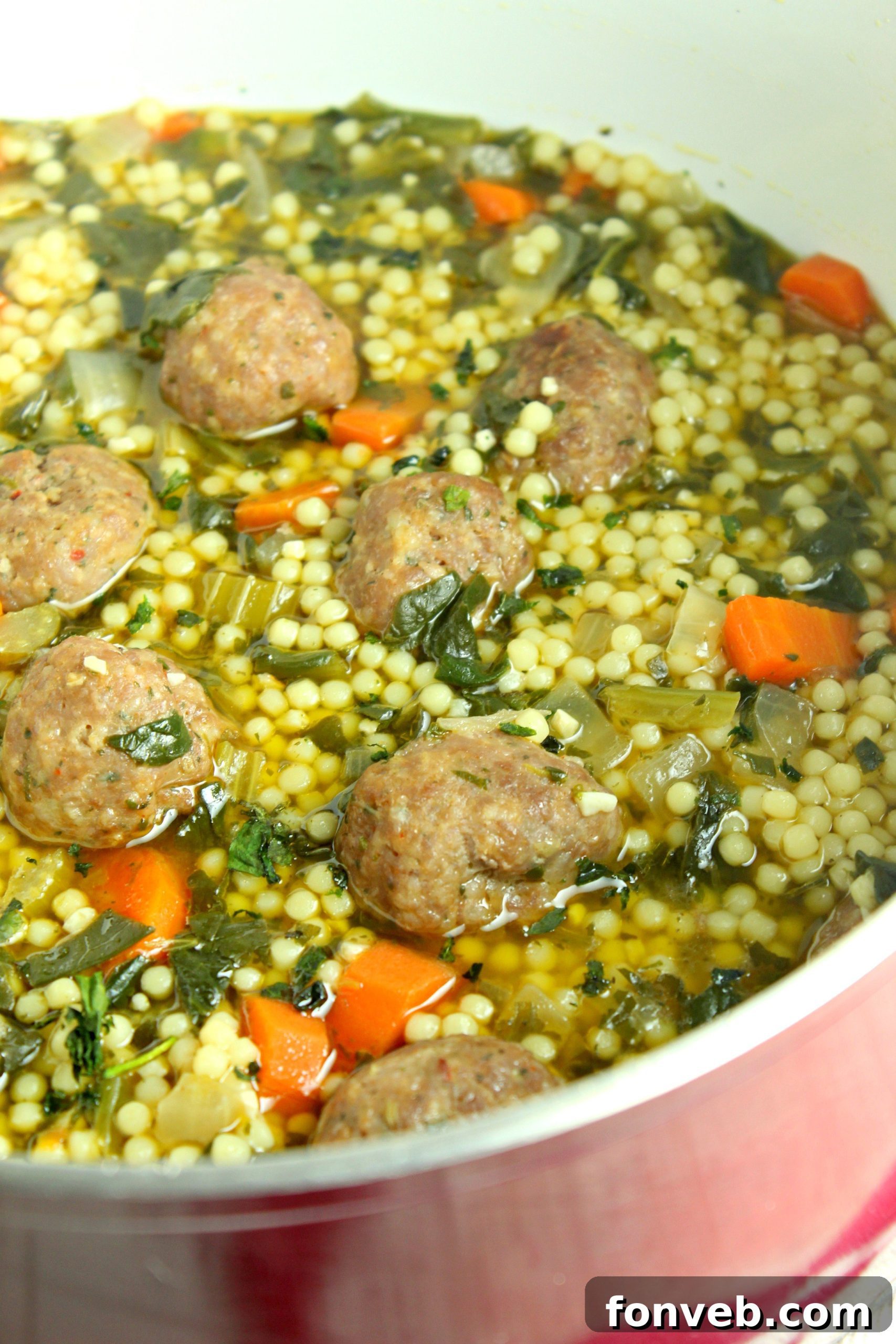 Prepared Italian Wedding Soup portions stored in clear, freezer-safe containers for convenient meal prepping.