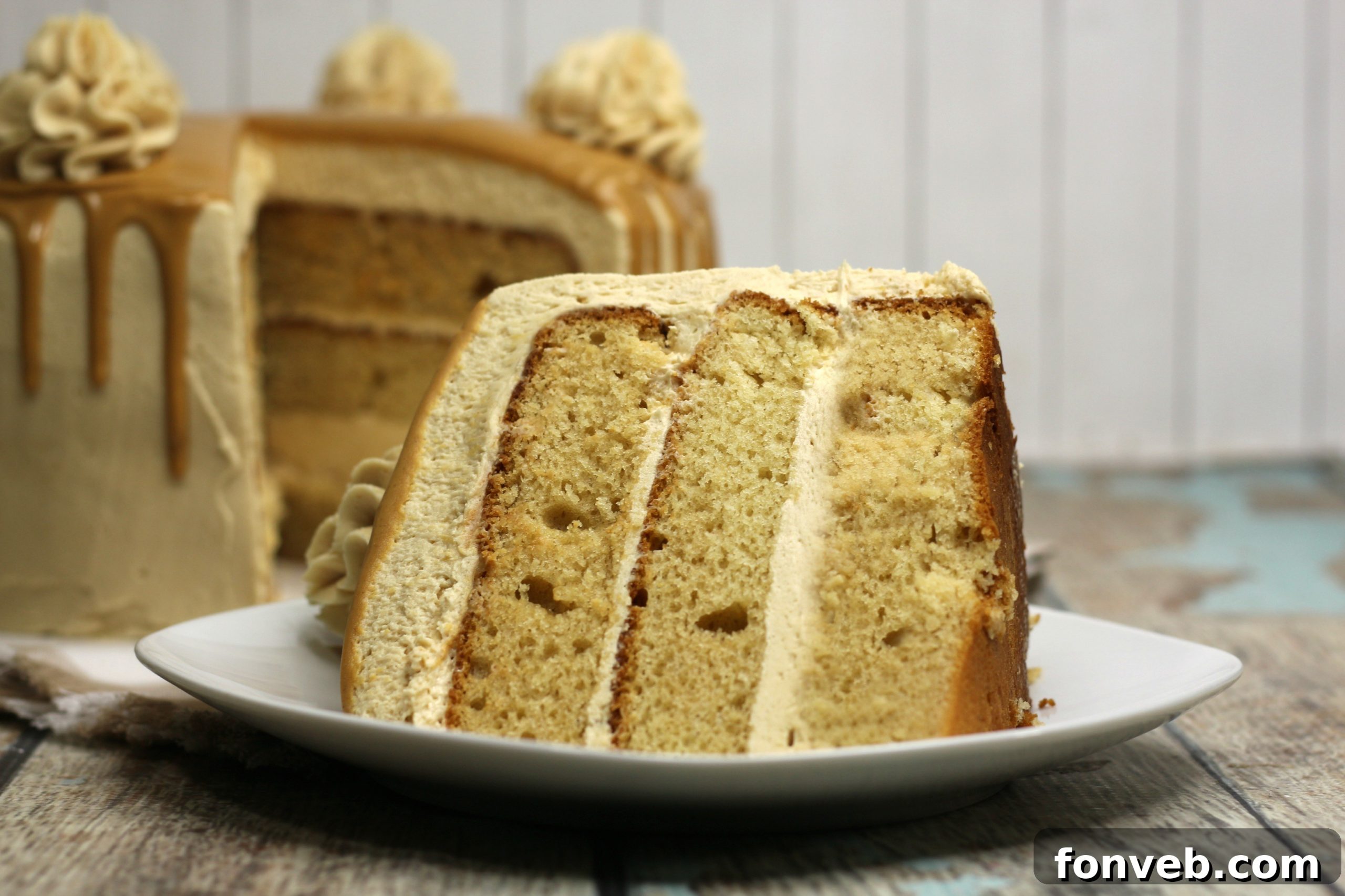 The Irresistible Peanut Butter Cake Experience 11 A slice of peanut butter layered cake served alongside a tall glass of cold milk, highlighting the classic pairing for this rich dessert.