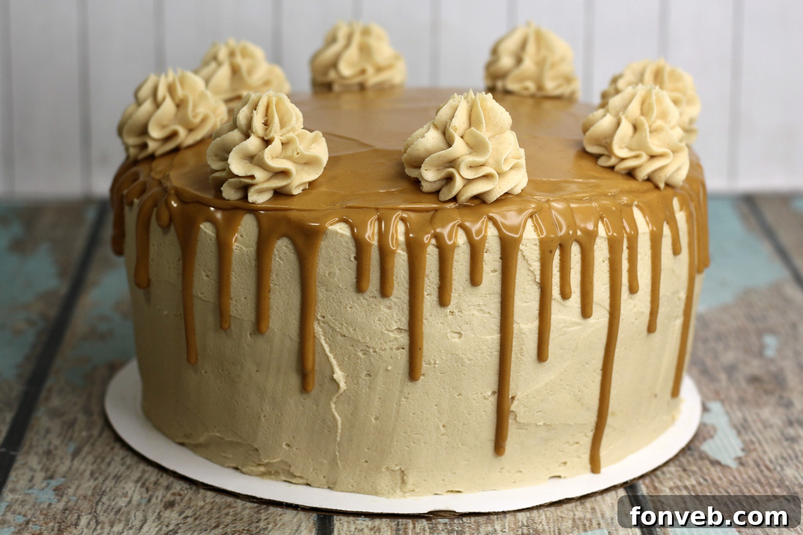 The Irresistible Peanut Butter Cake Experience 3 Close-up of a slice of peanut butter cake, revealing moist layers, creamy frosting, and the luxurious peanut butter drizzle cascading down the sides.