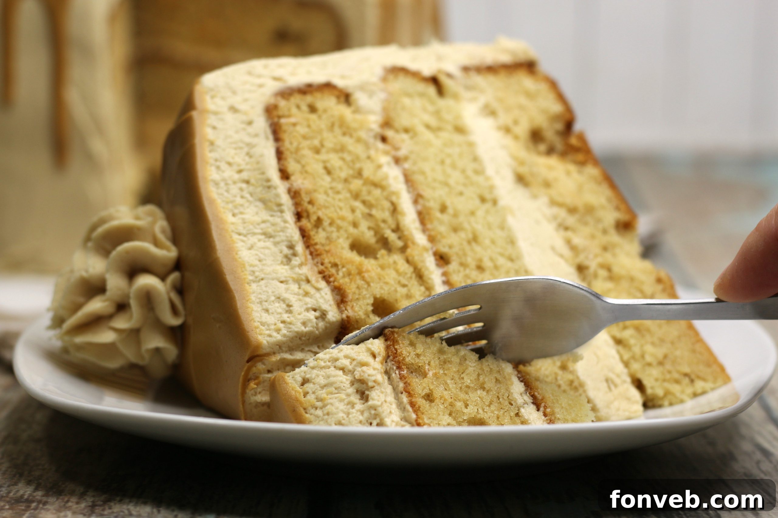 The Irresistible Peanut Butter Cake Experience 6 The peanut butter layered cake adorned with additional toppings like chocolate shavings and miniature peanut butter cups, enhancing its visual appeal.