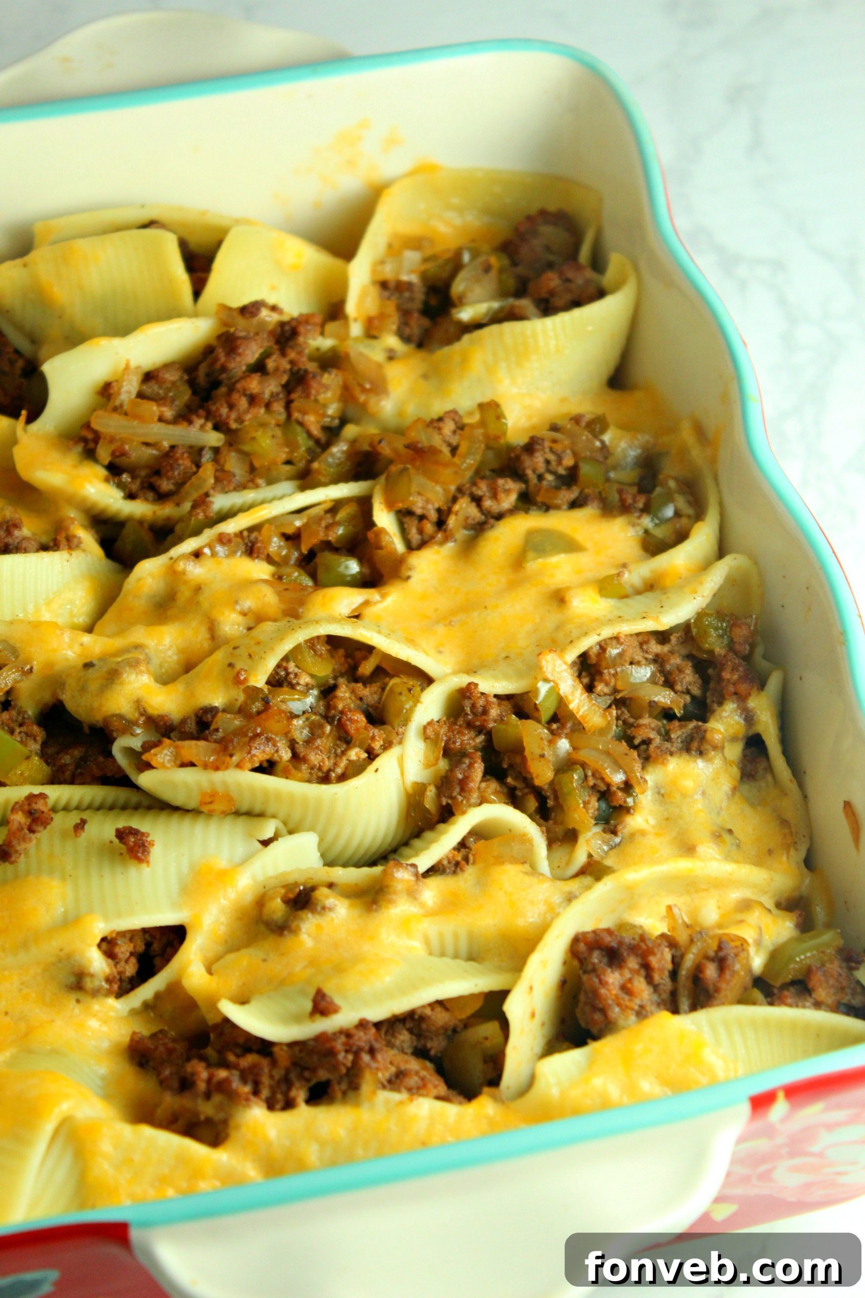 A close-up of a single stuffed pasta shell, showcasing the rich filling and melted cheese.