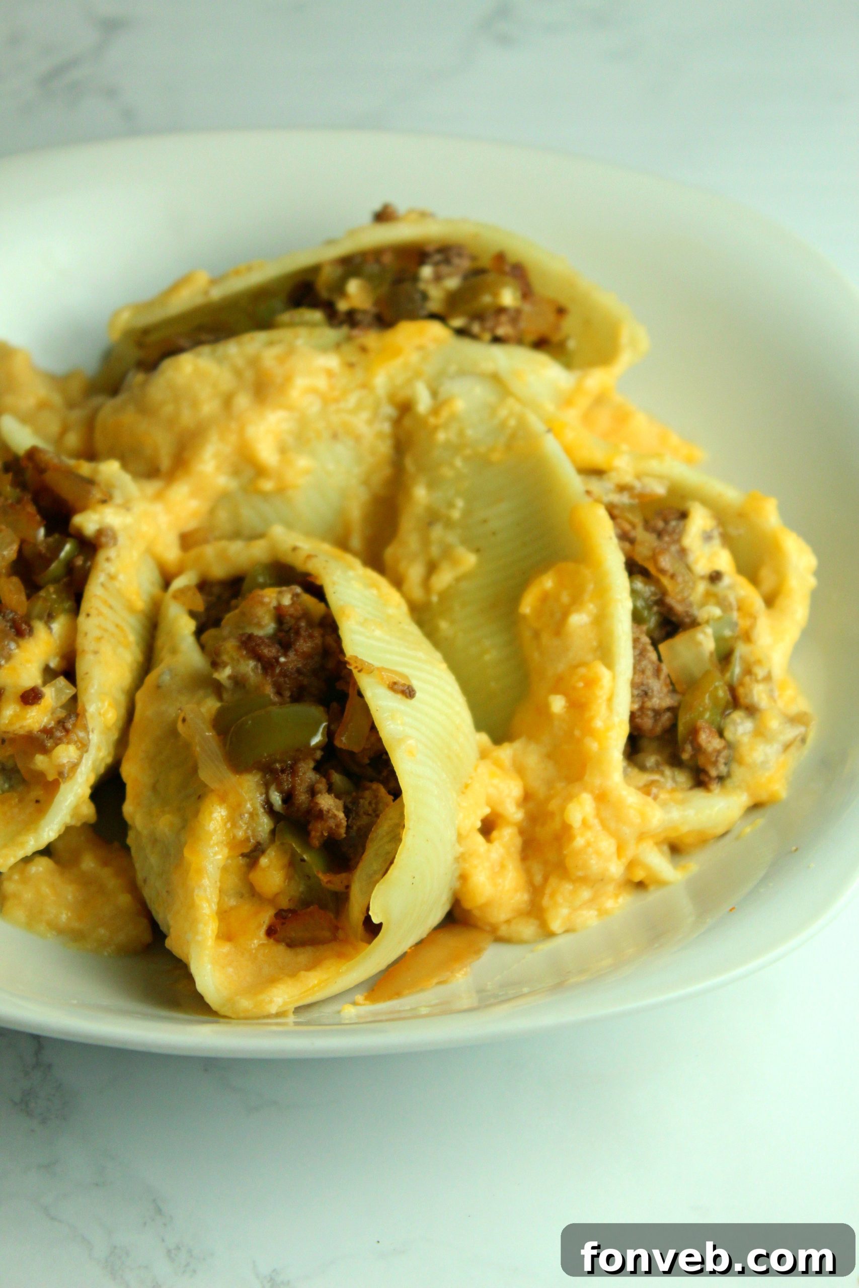 A golden-brown dish of Philly Cheese Steak Stuffed Shells, fresh out of the oven, ready to serve.