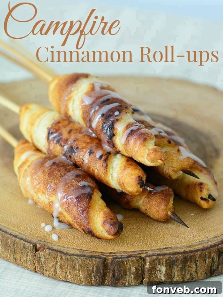 Delicious Campfire Cinnamon Roll-Ups, golden brown and glistening, cooked over an open fire.