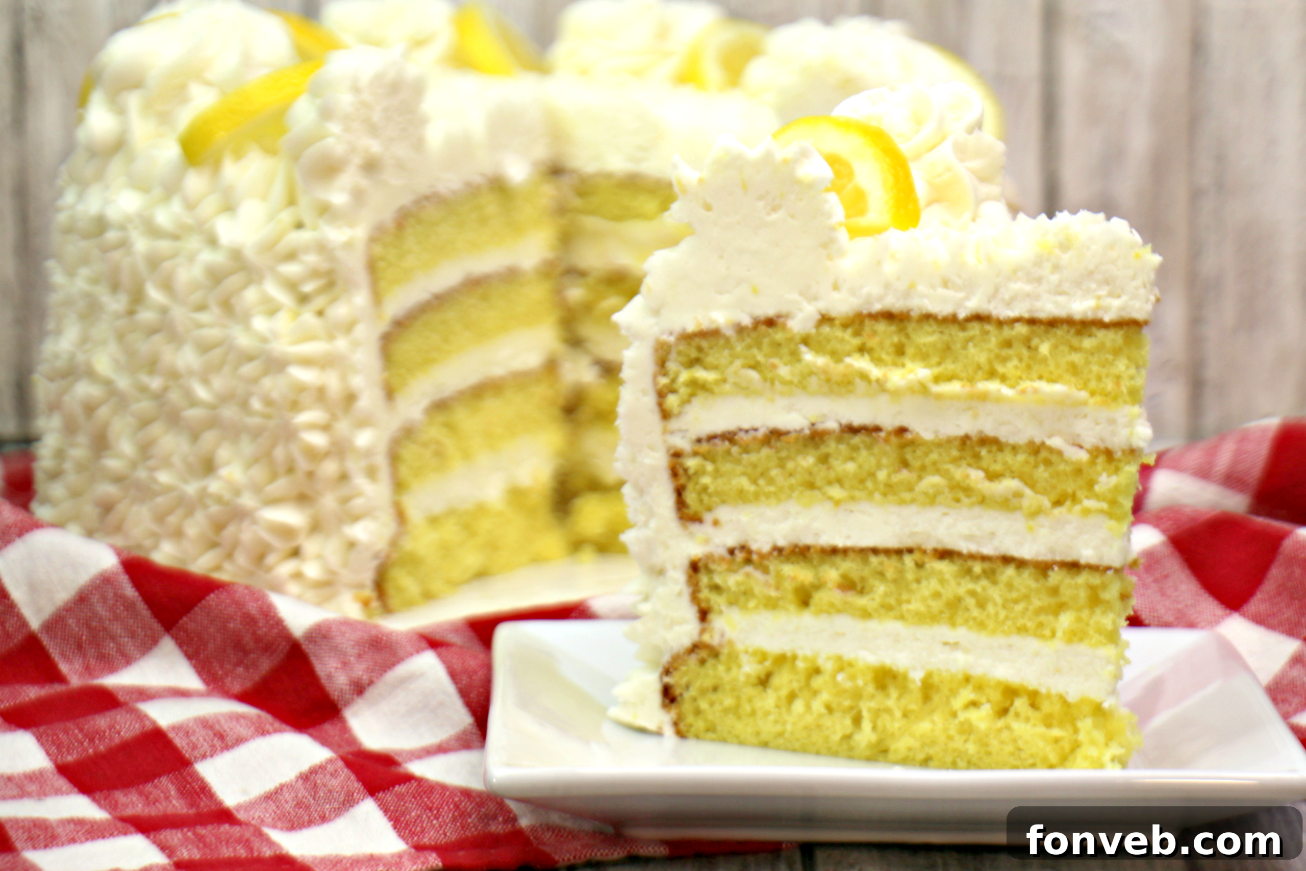 The process of layering a cake with rich frosting, showing care and precision.