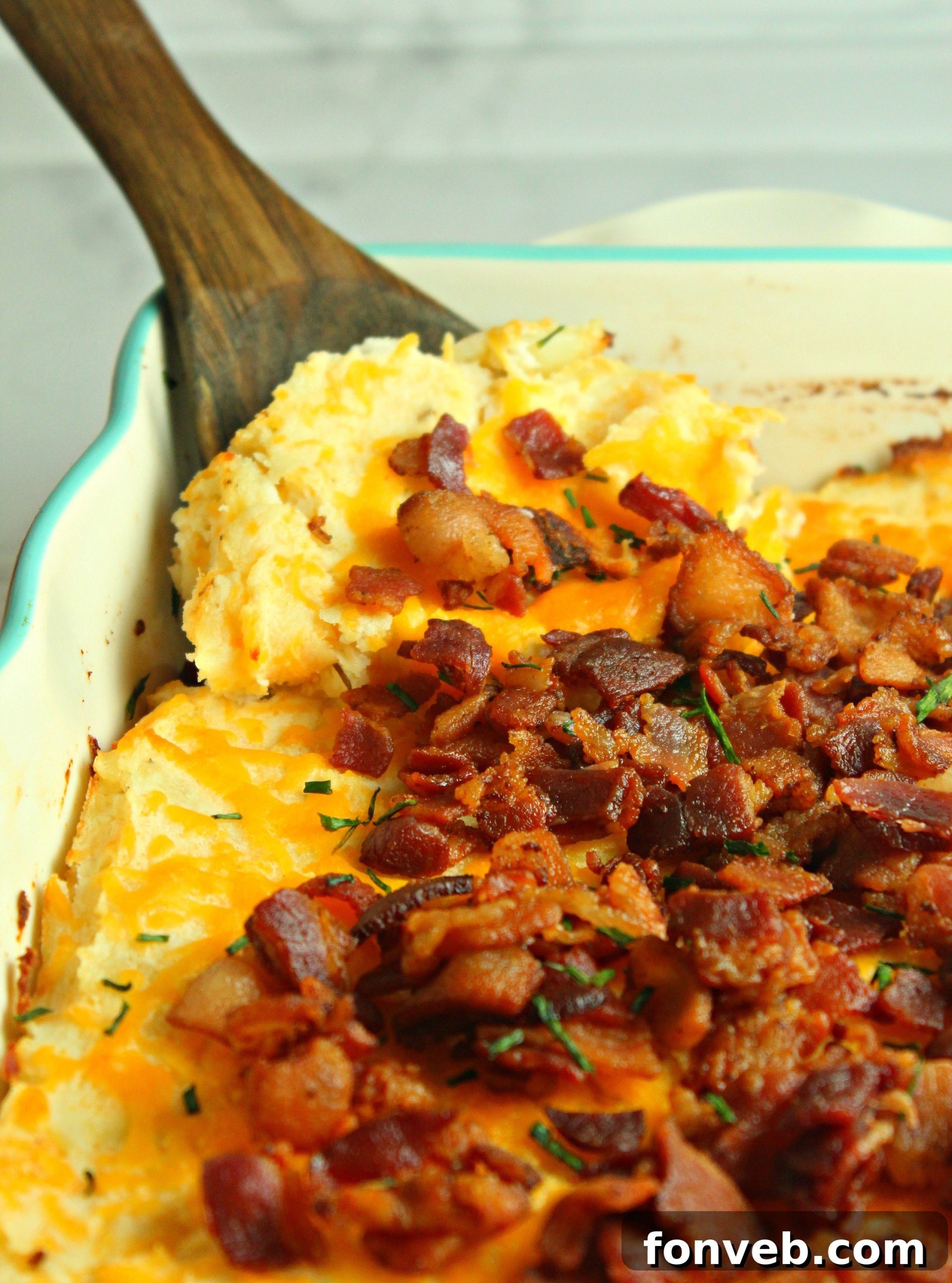 Ultimate Loaded Potato Bake 6 Loaded mashed potato casserole presented in a white baking dish, fresh out of the oven, with steam gently rising.