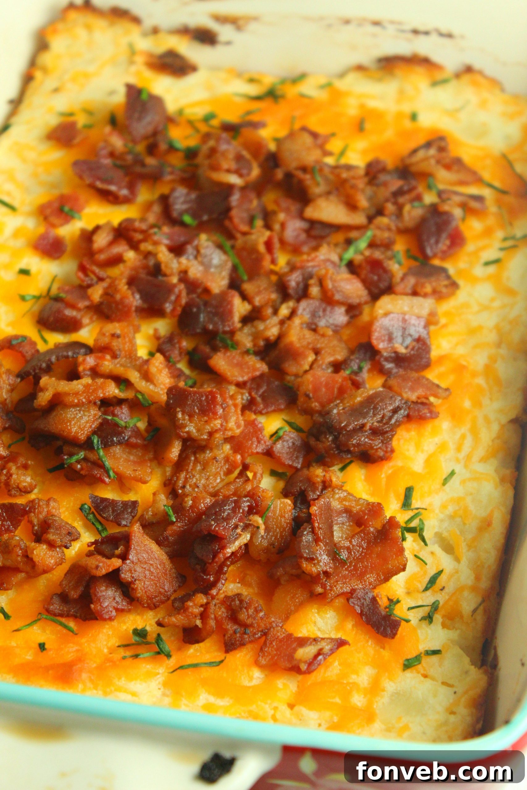 Ultimate Loaded Potato Bake 10 Loaded mashed potato casserole being served onto a plate from the baking dish.