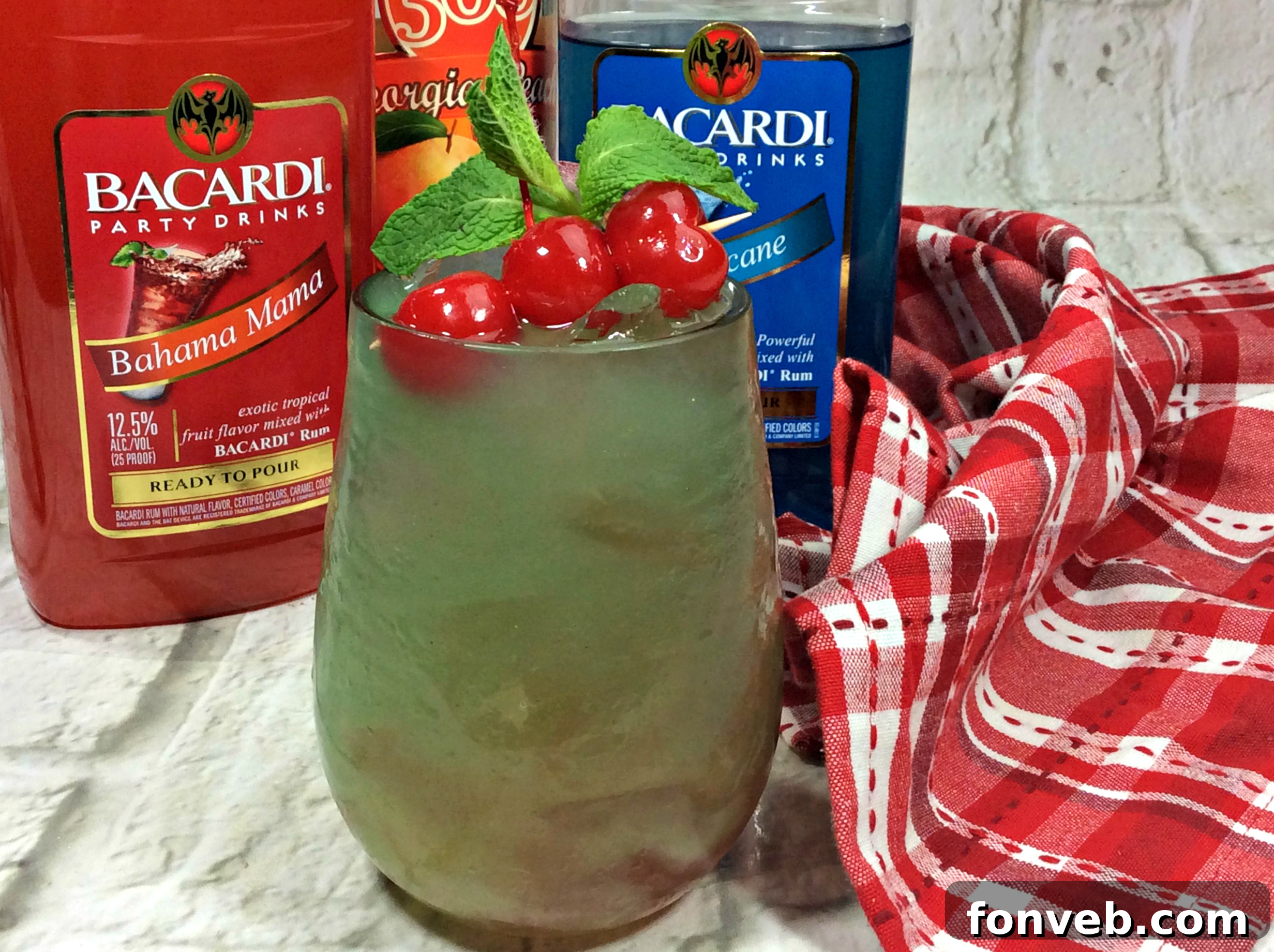 A close-up of the Sex on the Grass Cocktail being prepared in a shaker, surrounded by fresh ingredients.