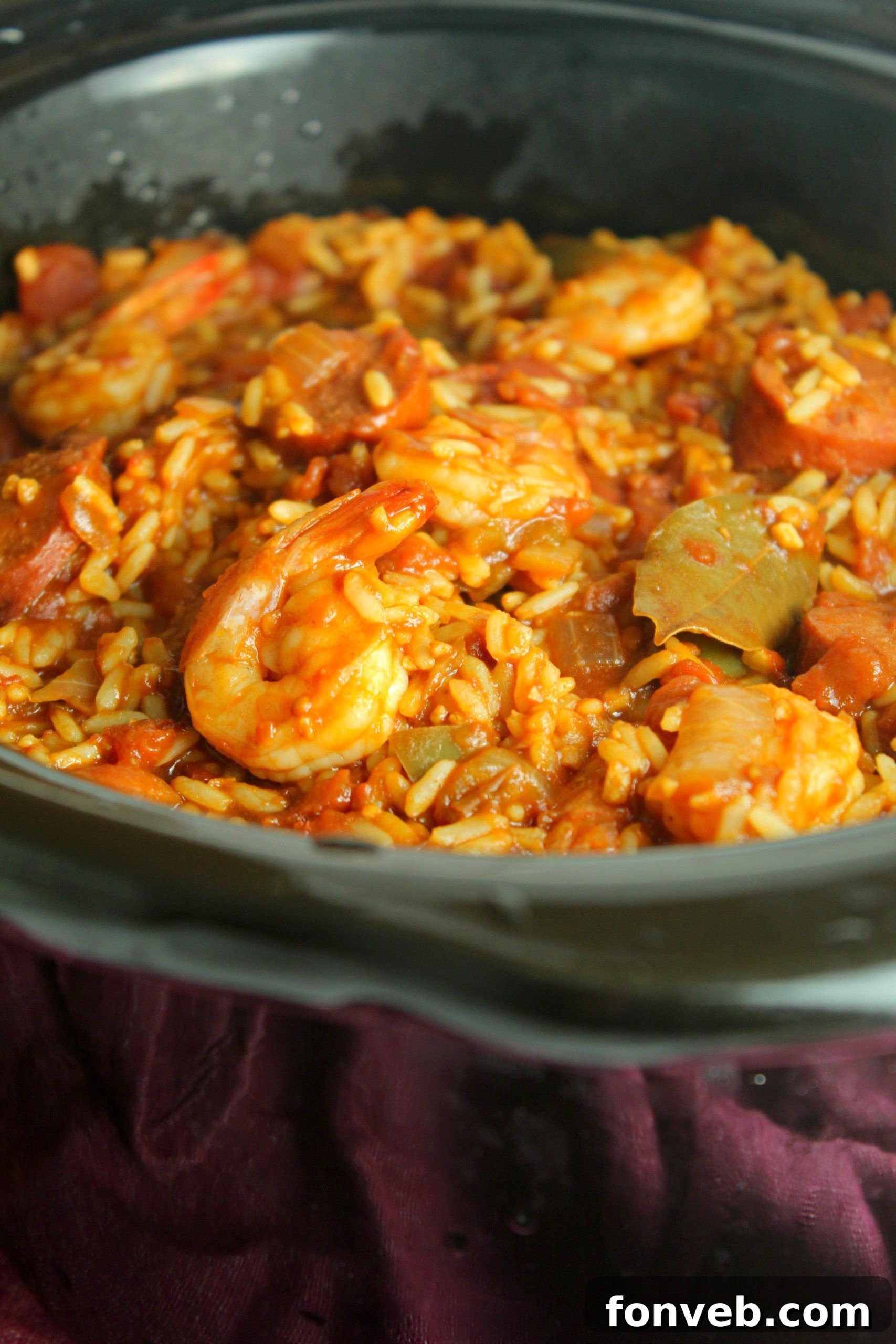 Ingredients for Slow Cooker Jambalaya laid out, including sausage, vegetables, and spices