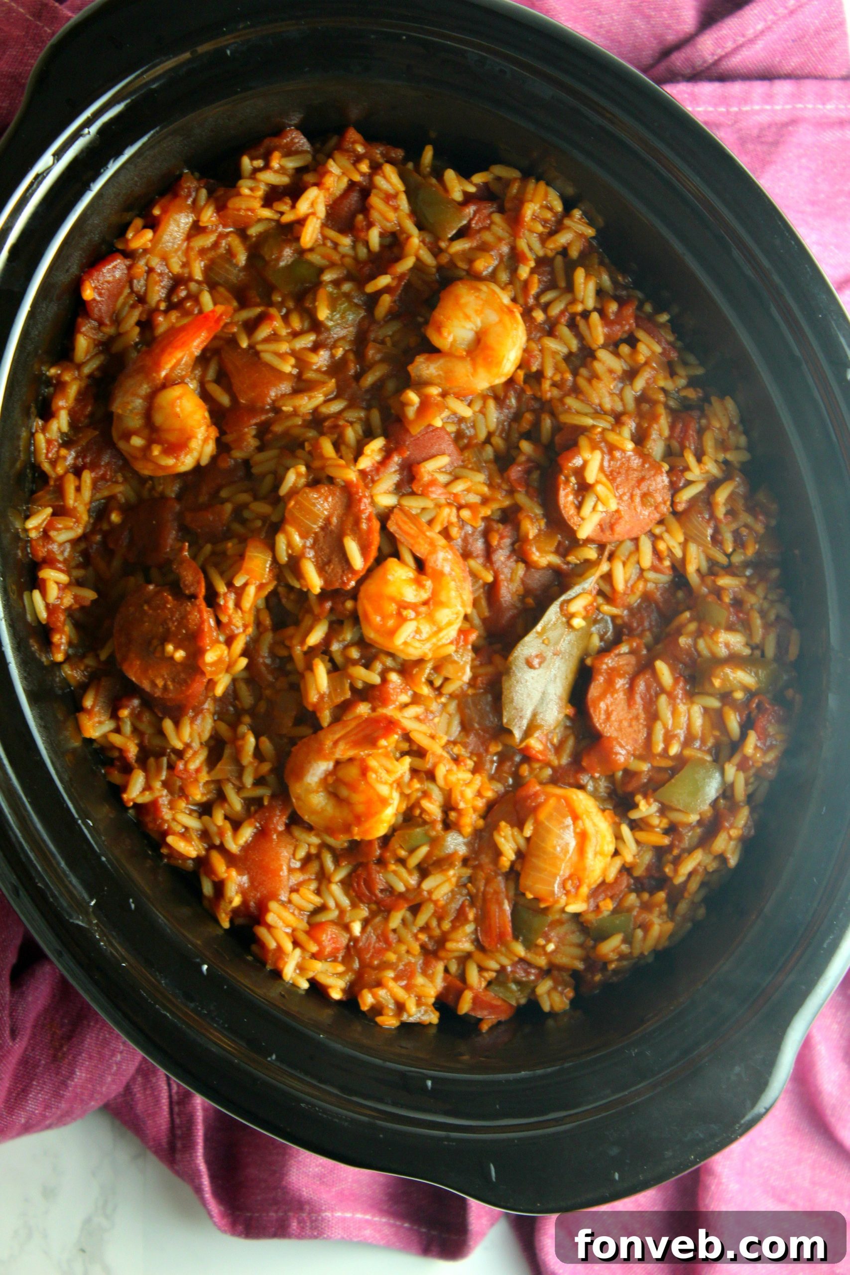 Delicious Slow Cooker Jambalaya garnished with fresh herbs in a bowl