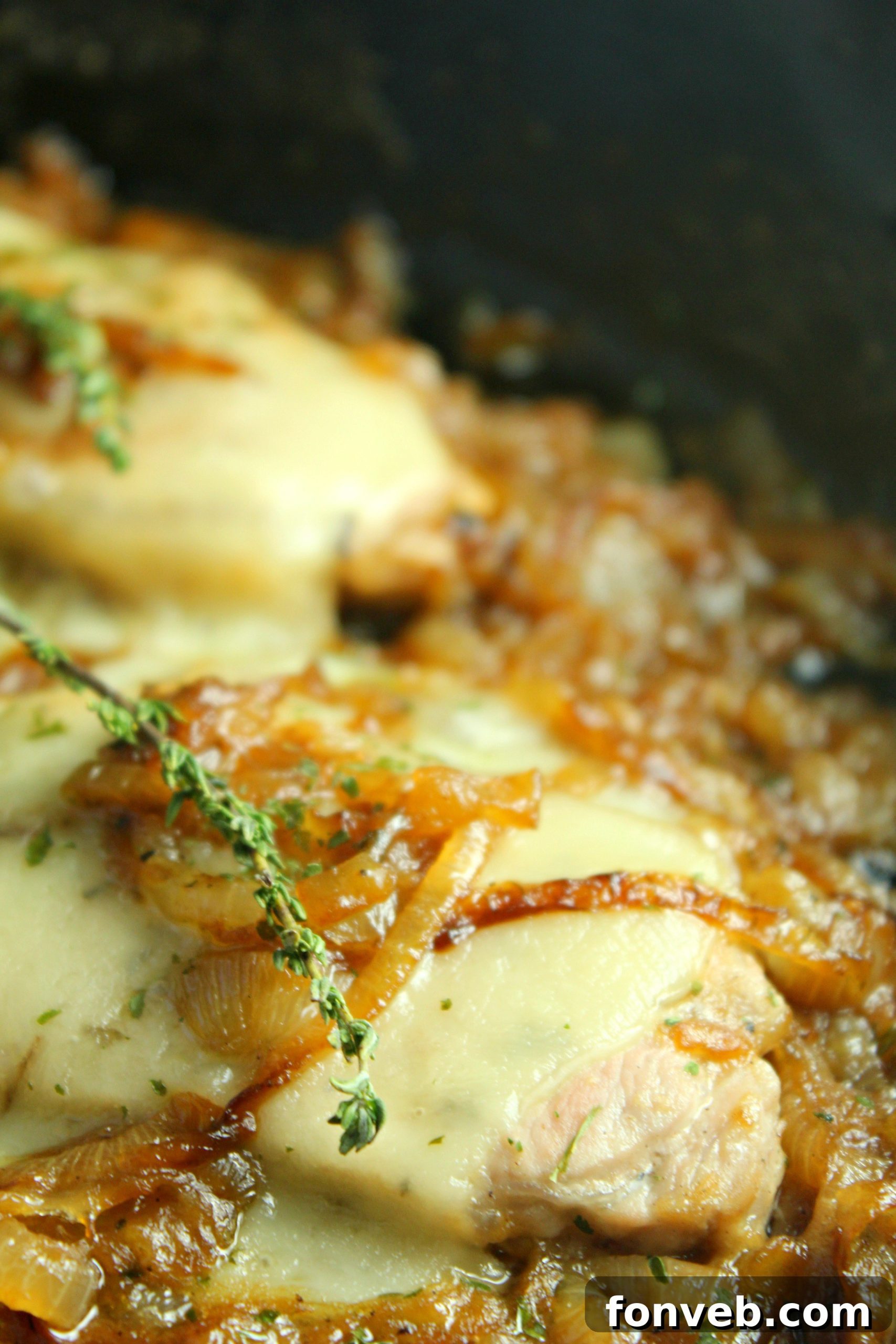 A serving of smothered French onion pork chops alongside a generous scoop of creamy mashed potatoes, ready for dinner