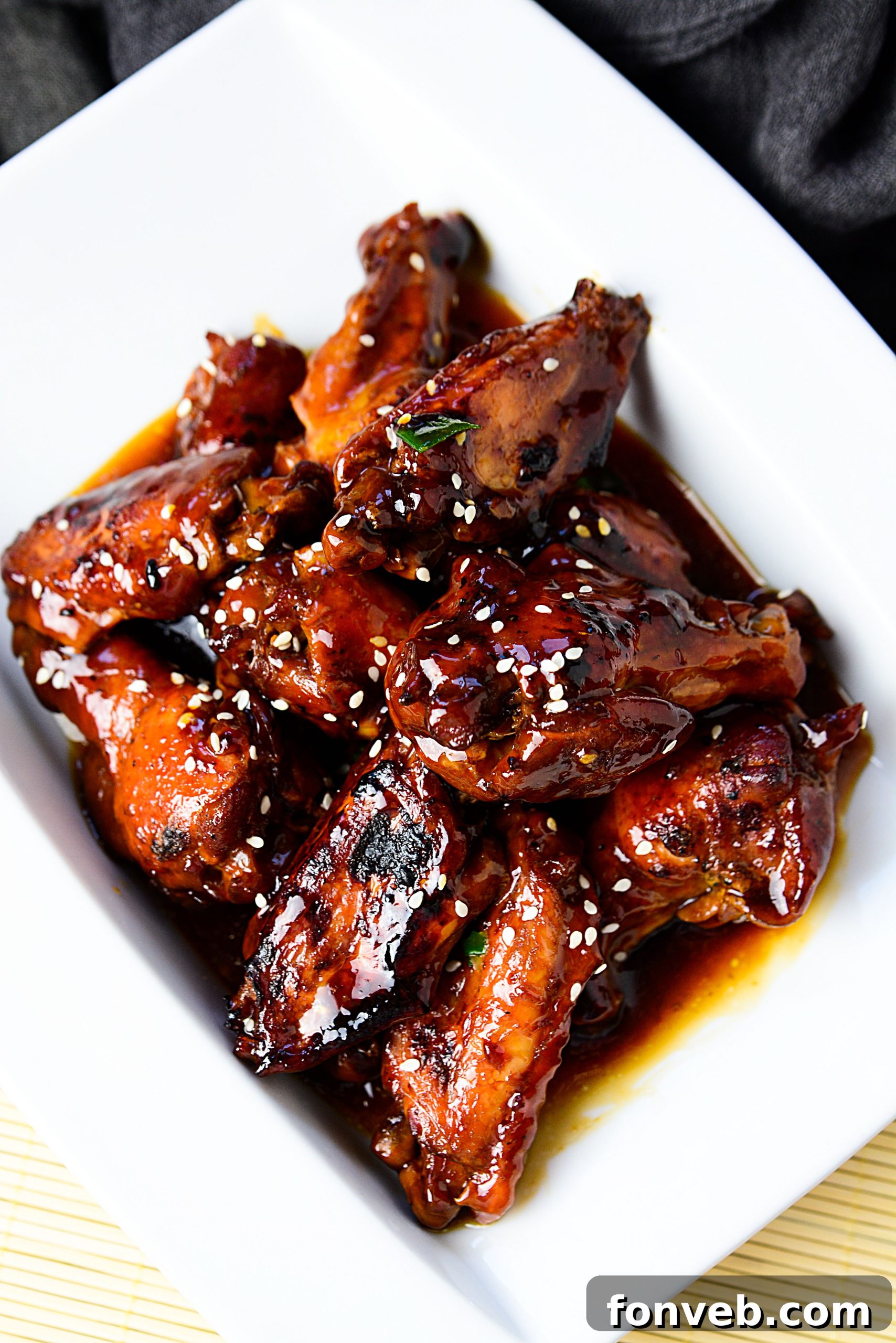 Slow Cooker Chicken Teriyaki Wings served on a white plate with sesame seeds