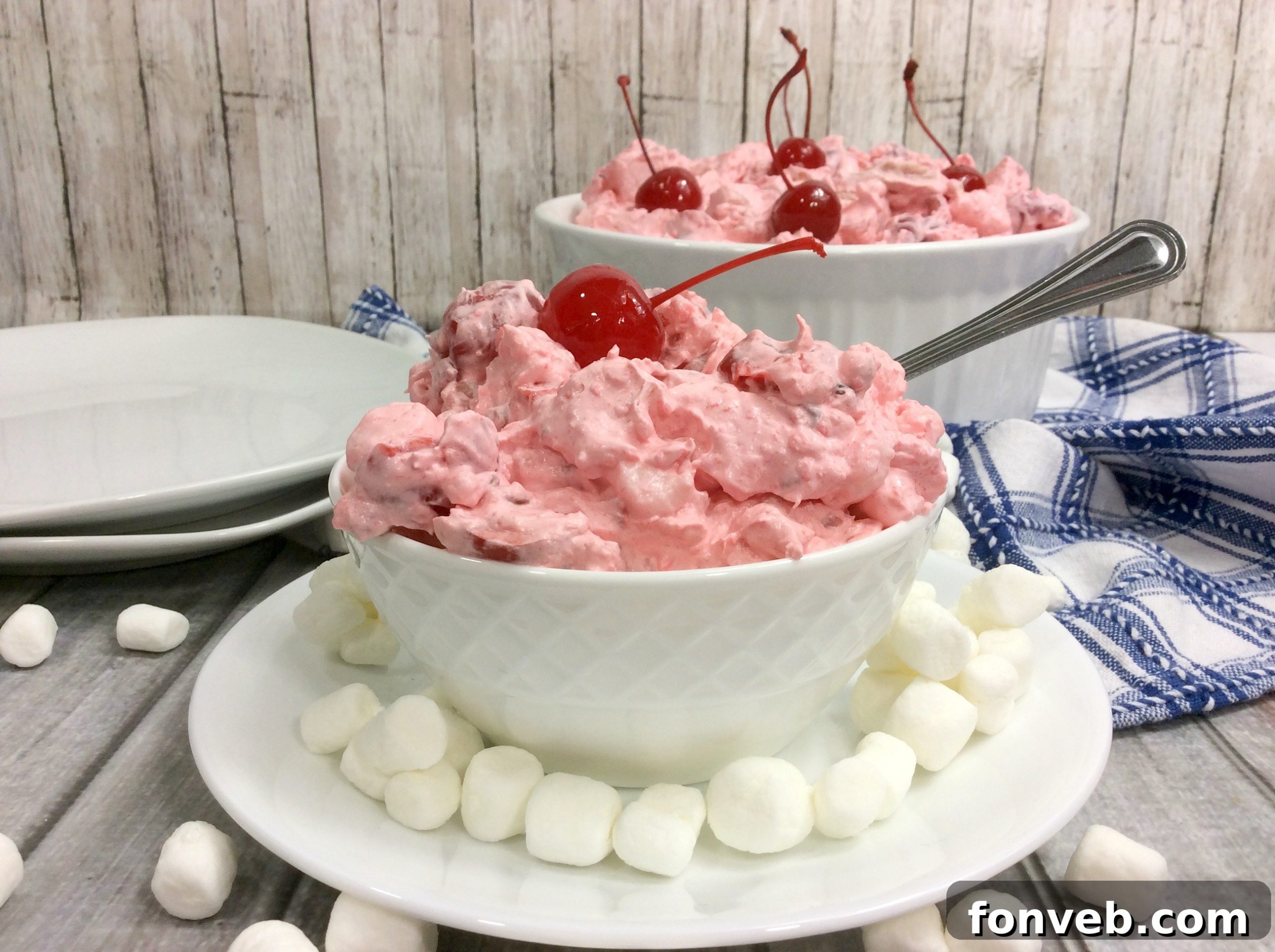 Cloud Nine Cherry Delight 6 A bowl of Cherry Fluff Salad, perfectly set and ready to serve, with a spoon.