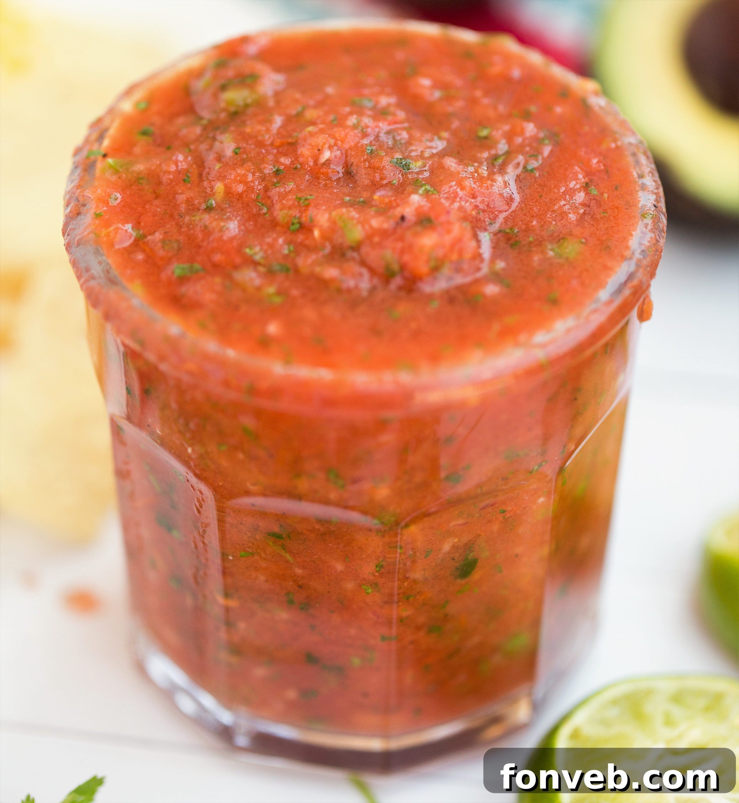 Signature Restaurant Salsa at Home 2 A bowl of vibrant homemade restaurant style salsa with crispy tortilla chips, garnished with fresh cilantro, ready to be enjoyed.