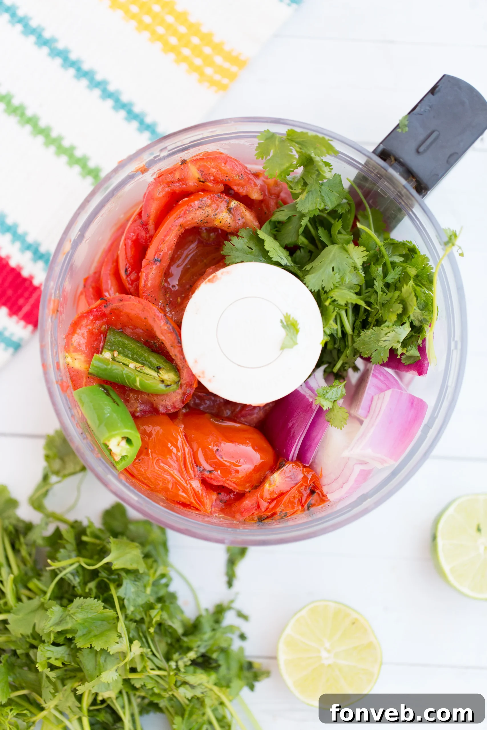 Signature Restaurant Salsa at Home 3 A selection of fresh ingredients for homemade salsa laid out on a cutting board: ripe Roma tomatoes, a red onion, a vibrant green jalapeño, garlic cloves, and a bunch of cilantro.