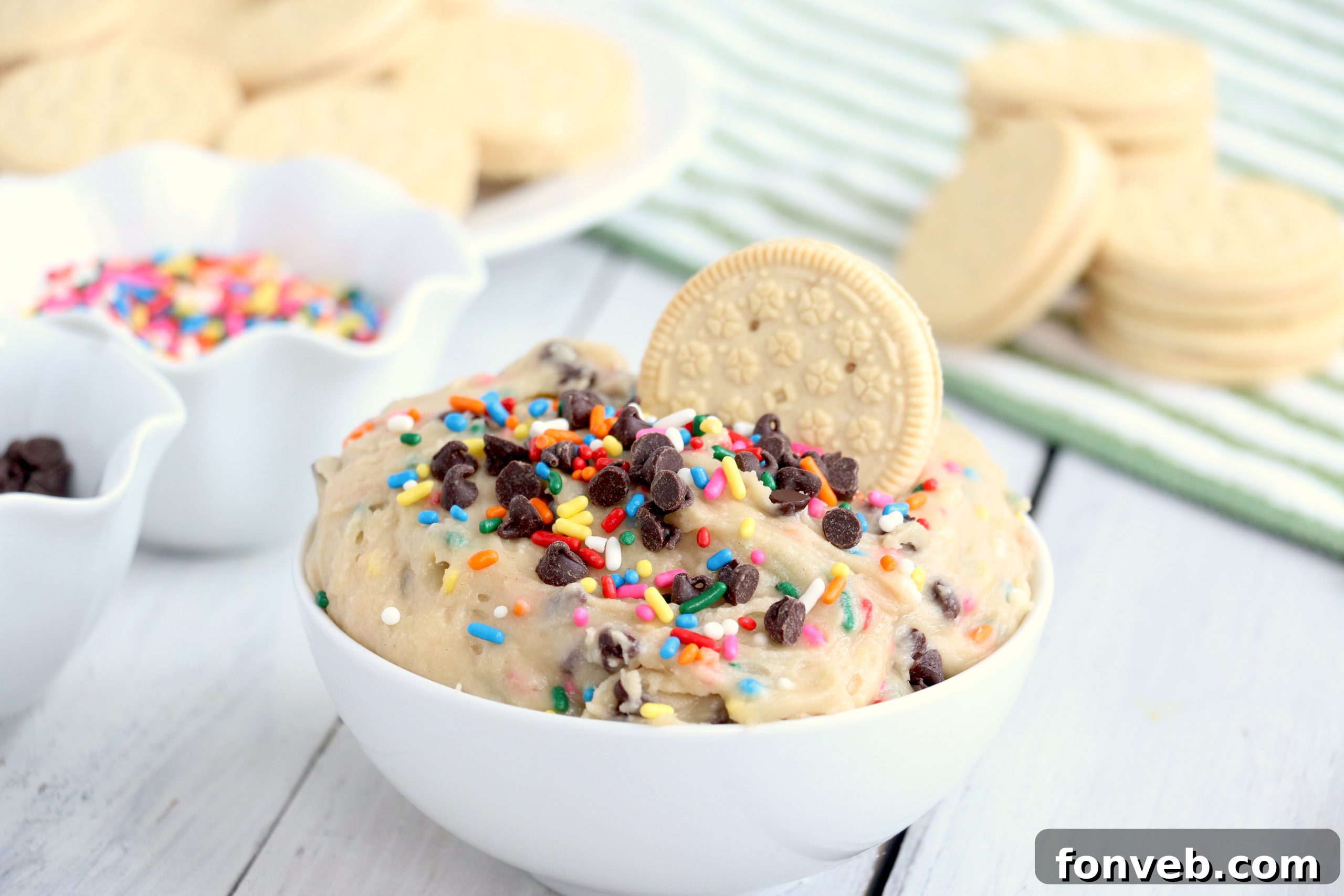 Ingredients for Funfetti Cookie Dough Dip laid out on a table: butter, sugar, vanilla, flour, salt, milk, sprinkles, mini chocolate chips.