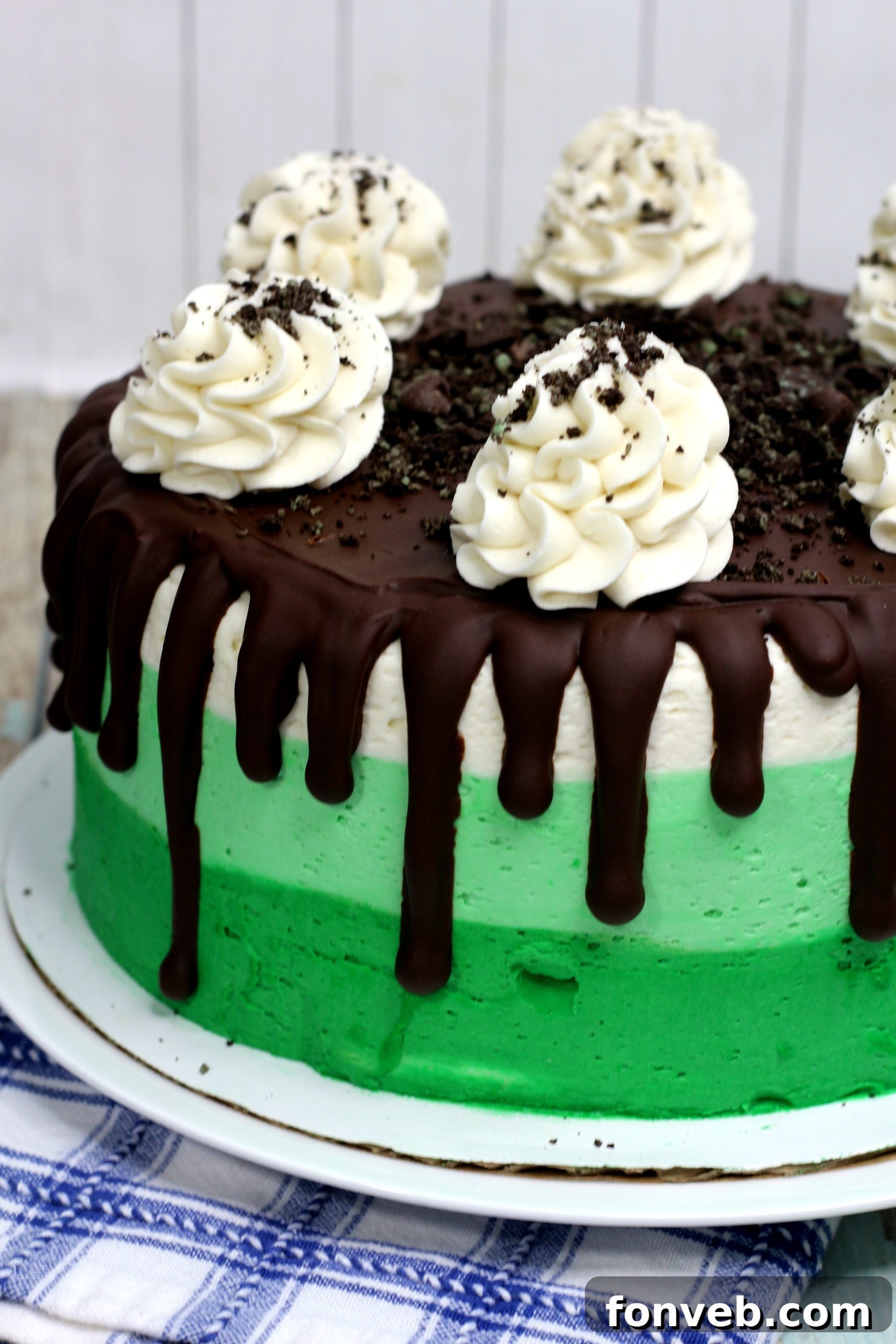 Cool Mint Oreo Decadence 2 Stunning Mint Oreo Layered Cake with ombre frosting and chocolate ganache drizzle, adorned with crushed and whole Mint Oreos.