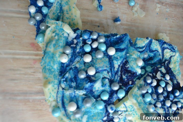 Close-up of melted white chocolate being mixed with blue food coloring for Frozen bark.