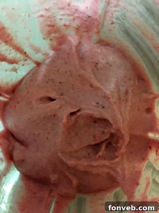 Adding white chocolate chips to the milkshake mixture in the blender.