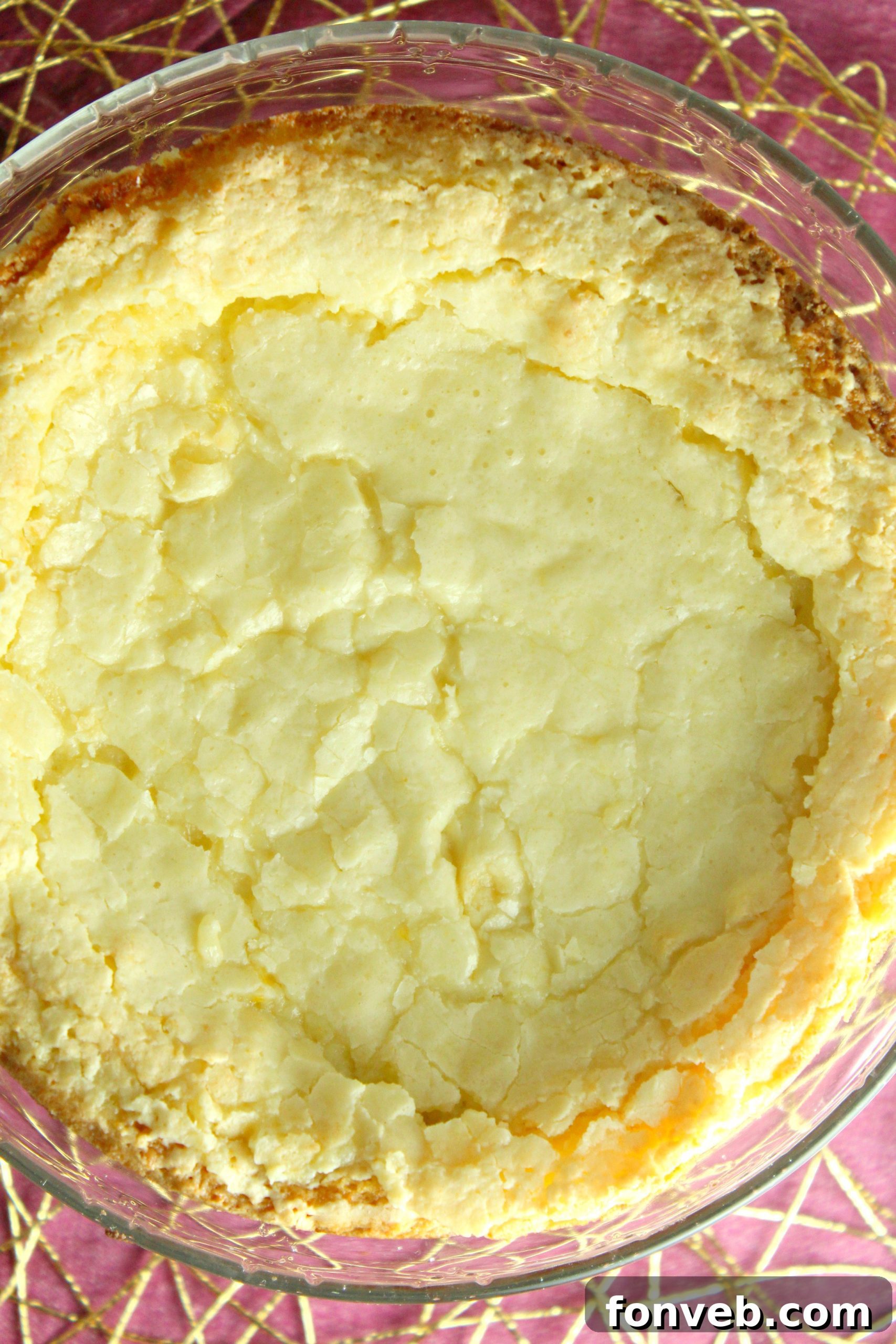 A slice of warm Ooey Gooey Butter Cake with a dollop of vanilla ice cream and whipped cream.